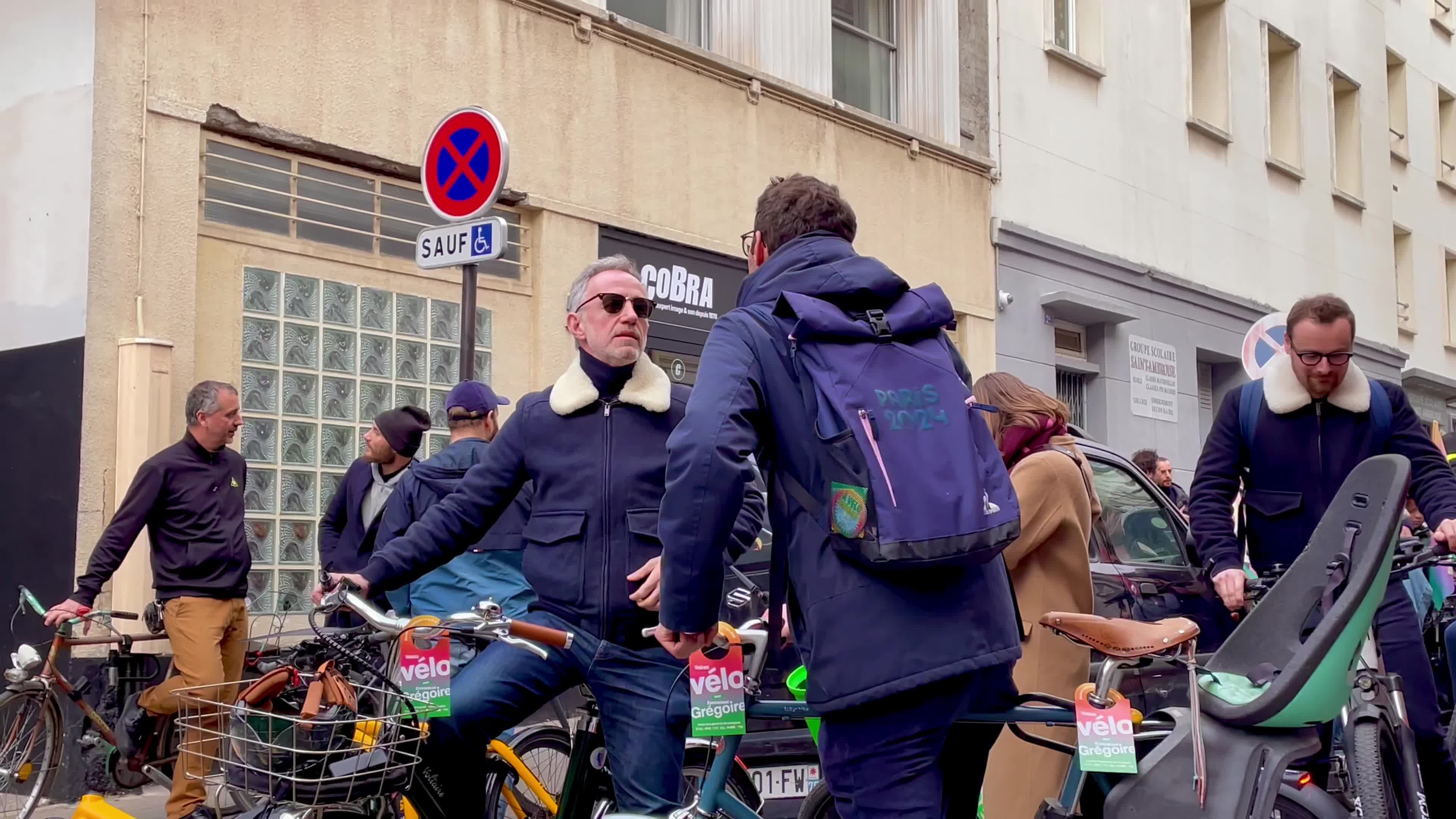Emmanuel Grégoire on a bicycle in the streets of Paris