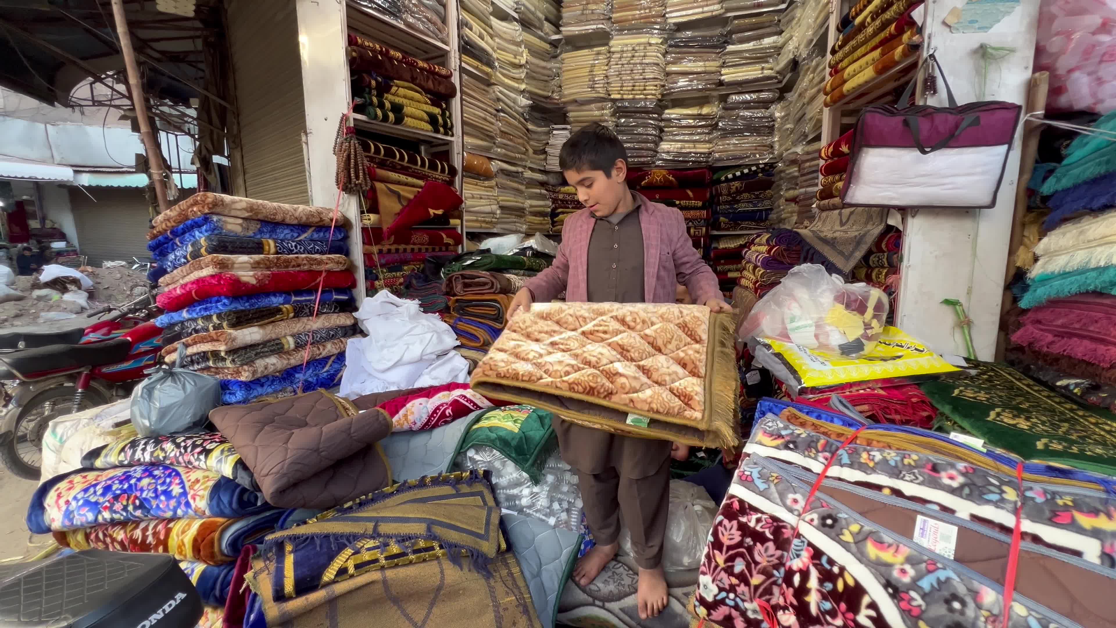 Vendors sell prayers mats and caps ahead of holy fasting month of Ramadan in Peshawar