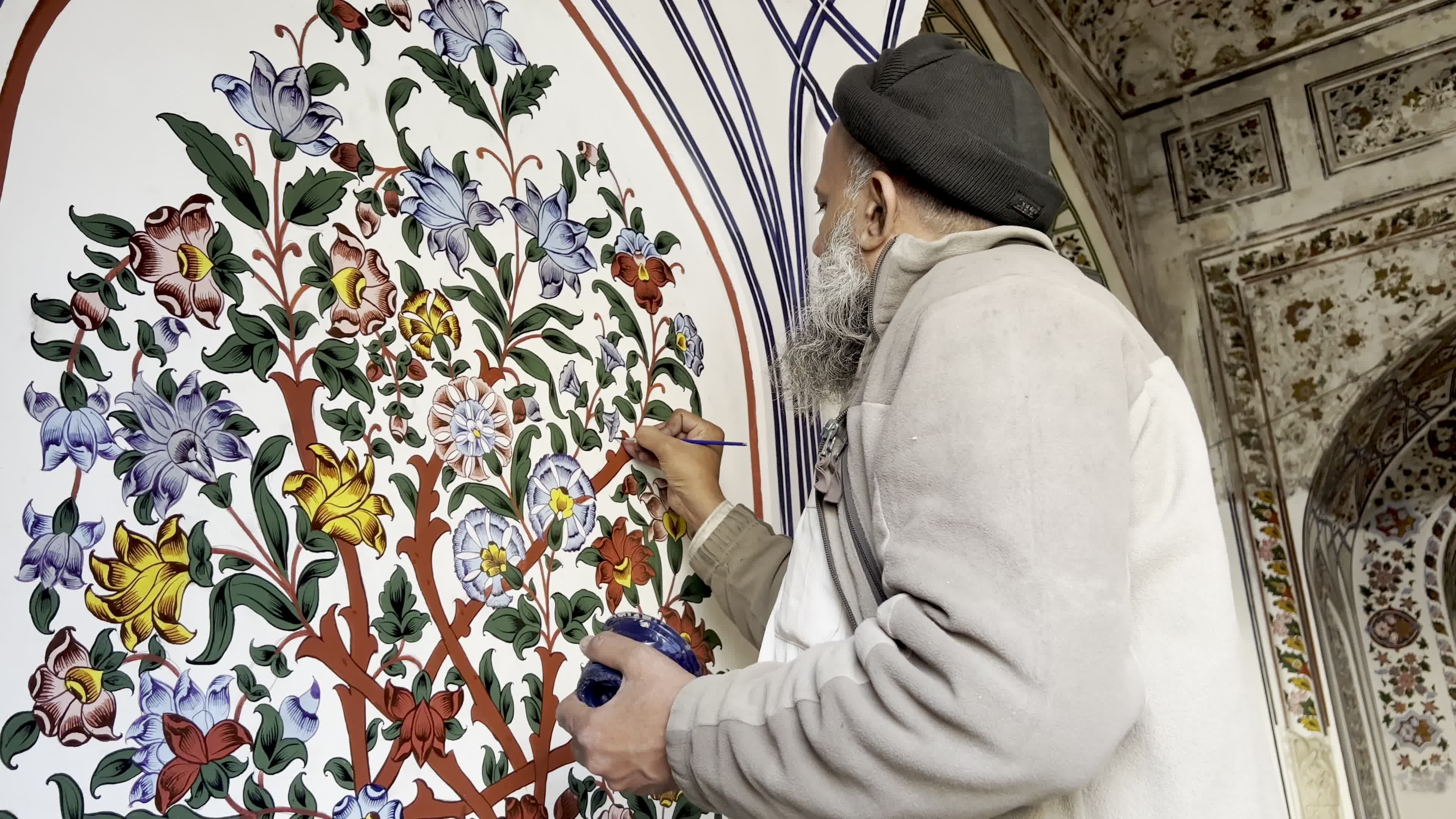 Artist Restores Floral Motifs at Historic Mohabbat Khan Mosque