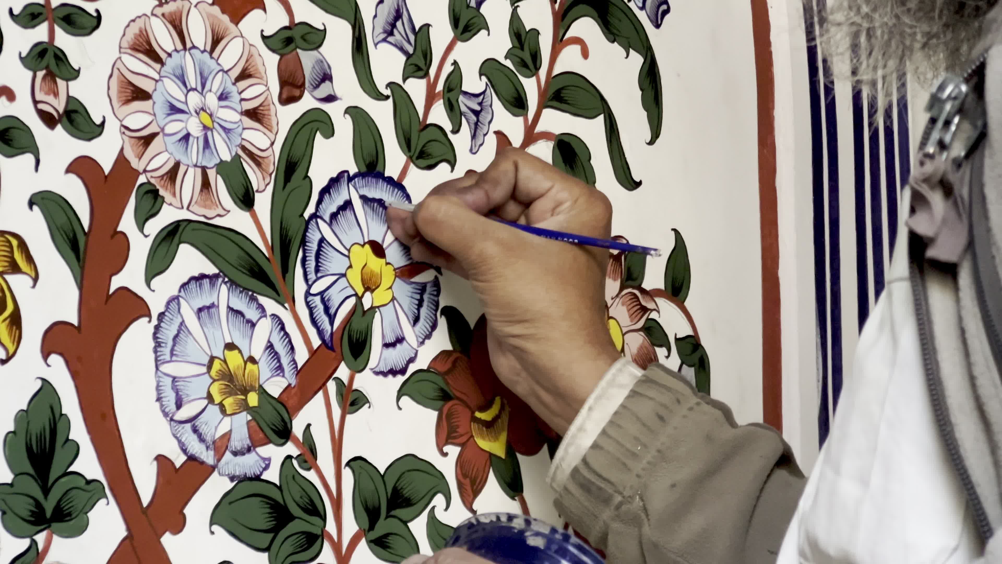Artist Restores Floral Motifs at Historic Mohabbat Khan Mosque