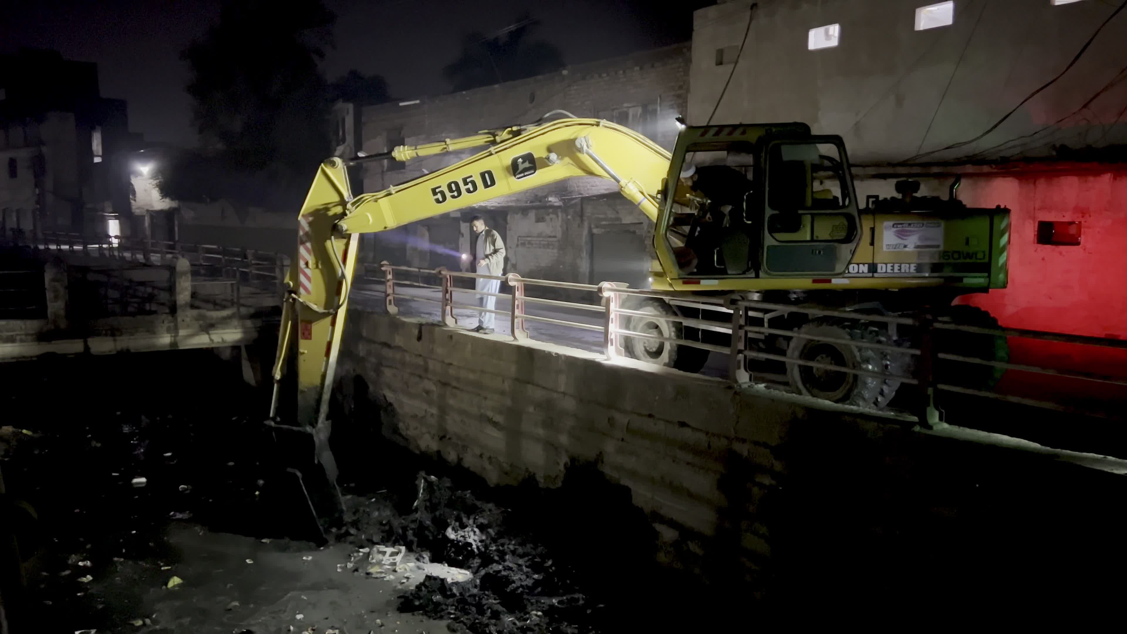 Excavator Clears Canal During Night Clean-Up in Peshawar