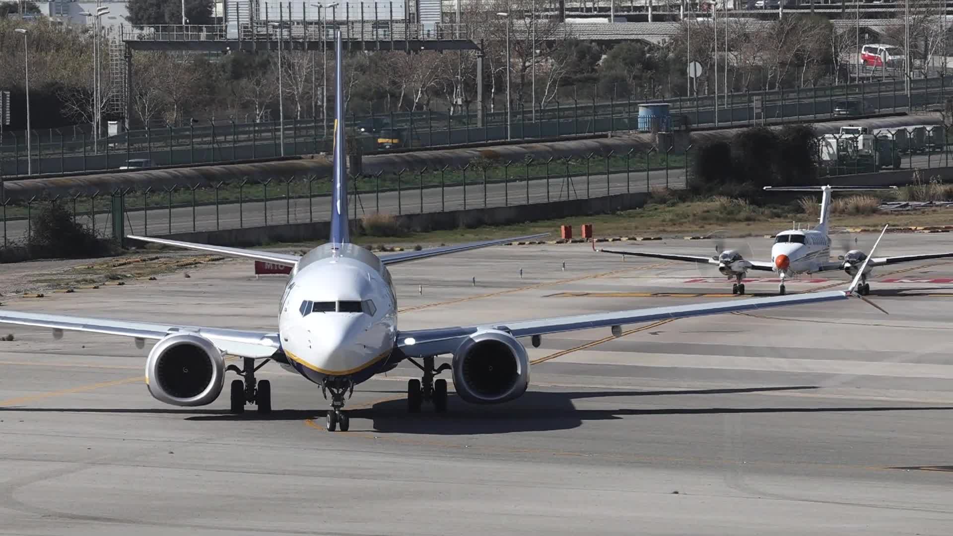 A Ryanair and a SENASA aircraft taxiing towards the runway at Barcelona Airport