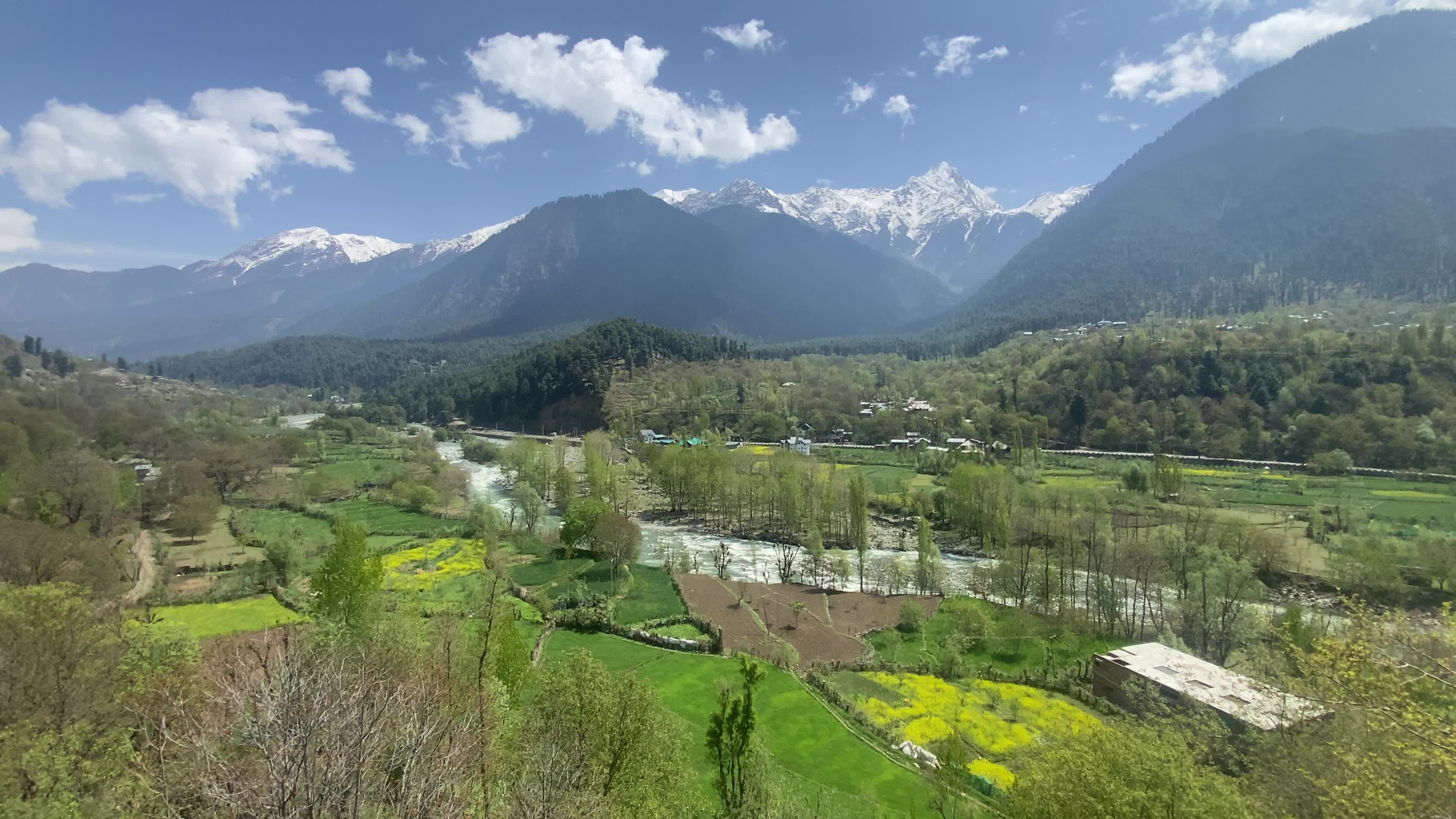 Pahalgam, in Indian side of Kashmir, is seen on a clear sunny day, as lush green valleys and surrounding hills are illuminated under bright skies.