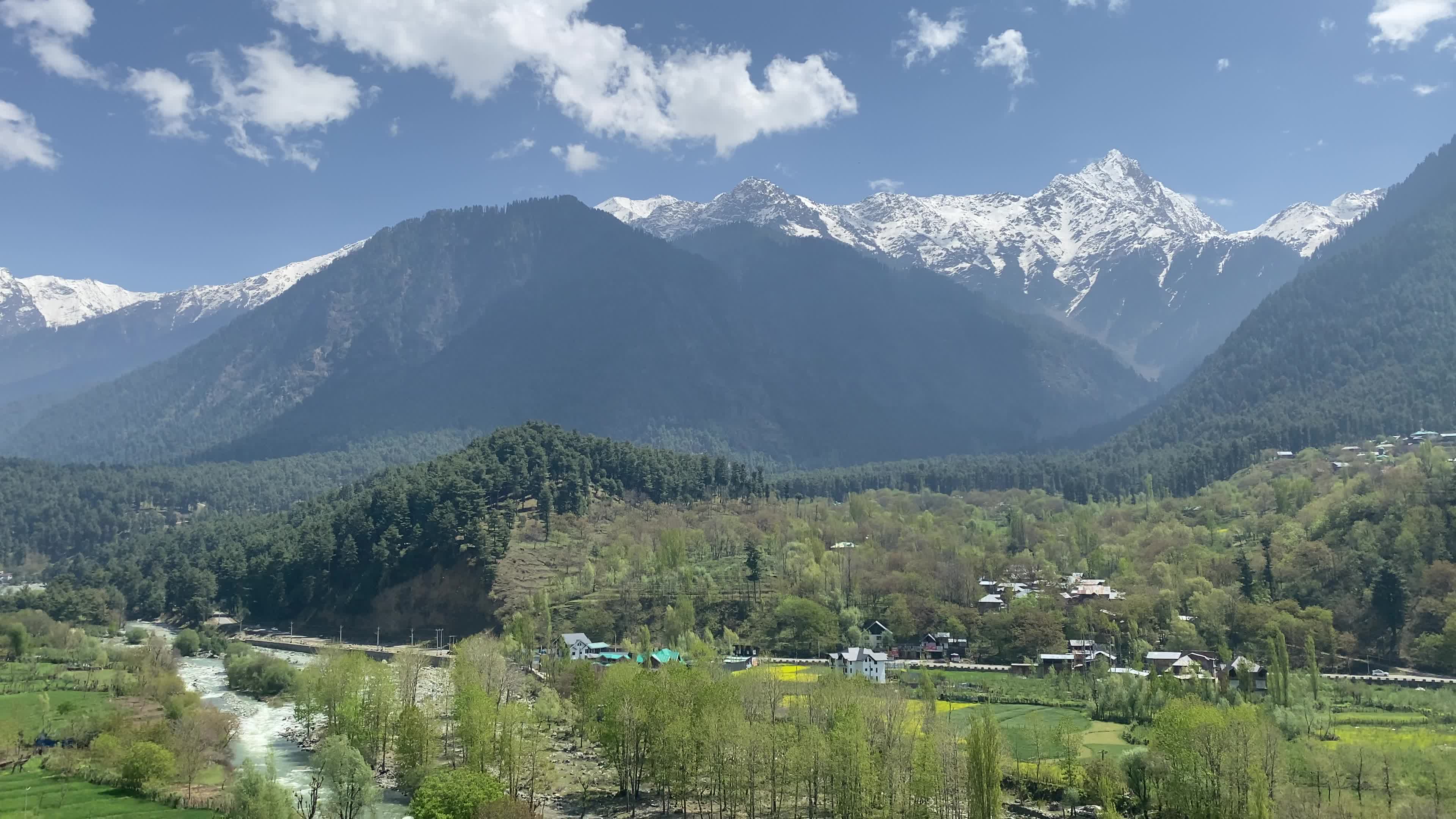 Pahalgam, in Indian side of Kashmir, is seen on a clear sunny day, as lush green valleys and surrounding hills are illuminated under bright skies.