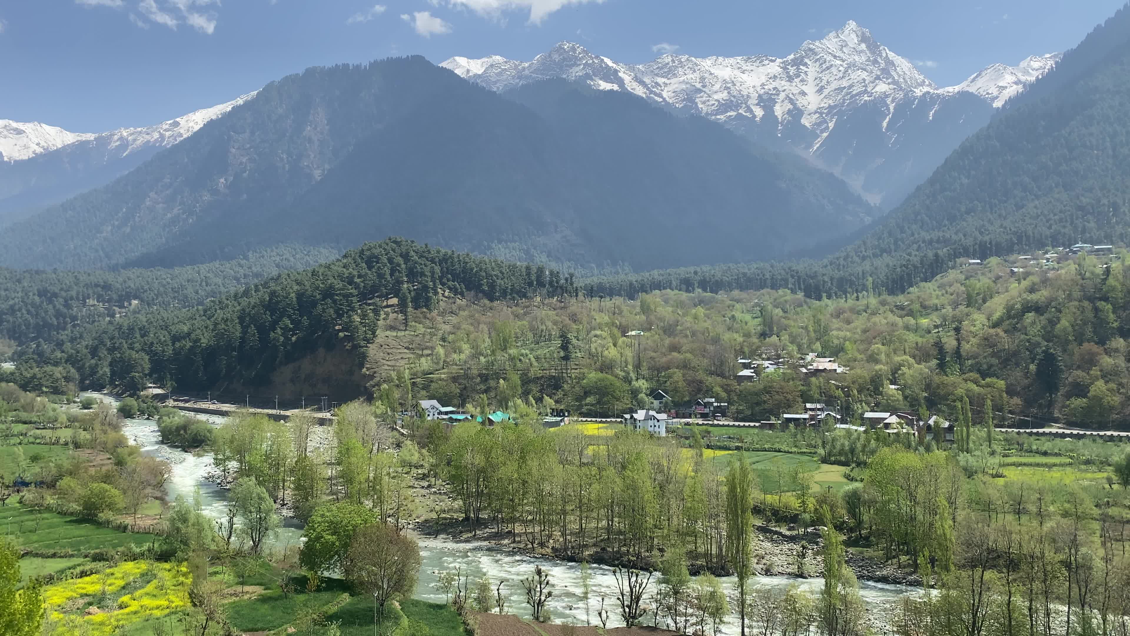 Pahalgam, in Indian side of Kashmir, is seen on a clear sunny day, as lush green valleys and surrounding hills are illuminated under bright skies.