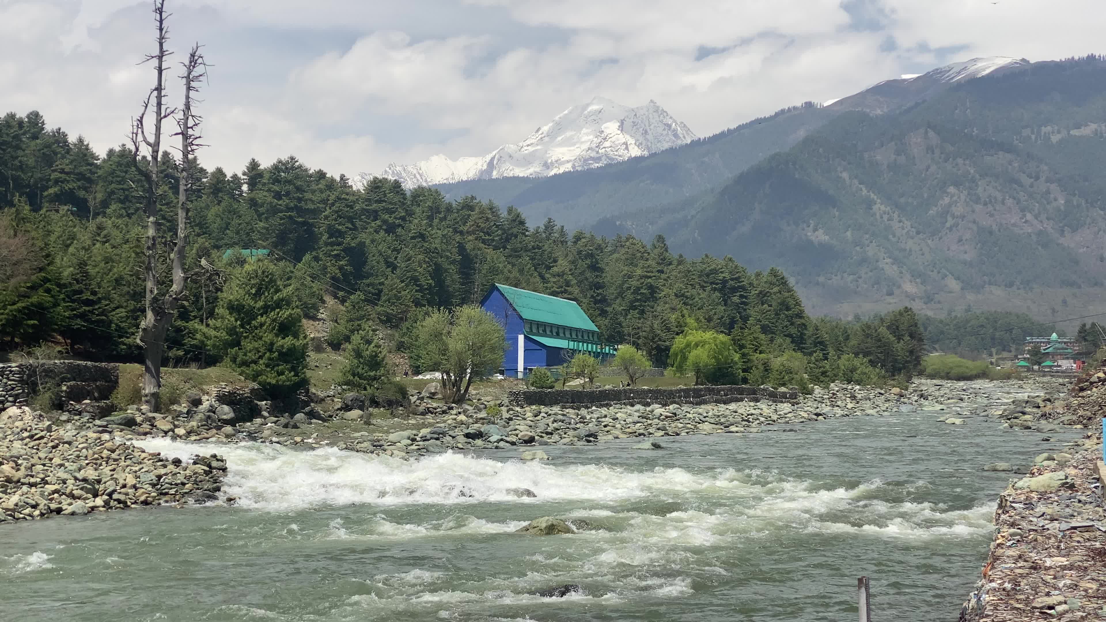 Pahalgam, in Indian side of Kashmir, is seen on a clear sunny day, as lush green valleys and surrounding hills are illuminated under bright skies.