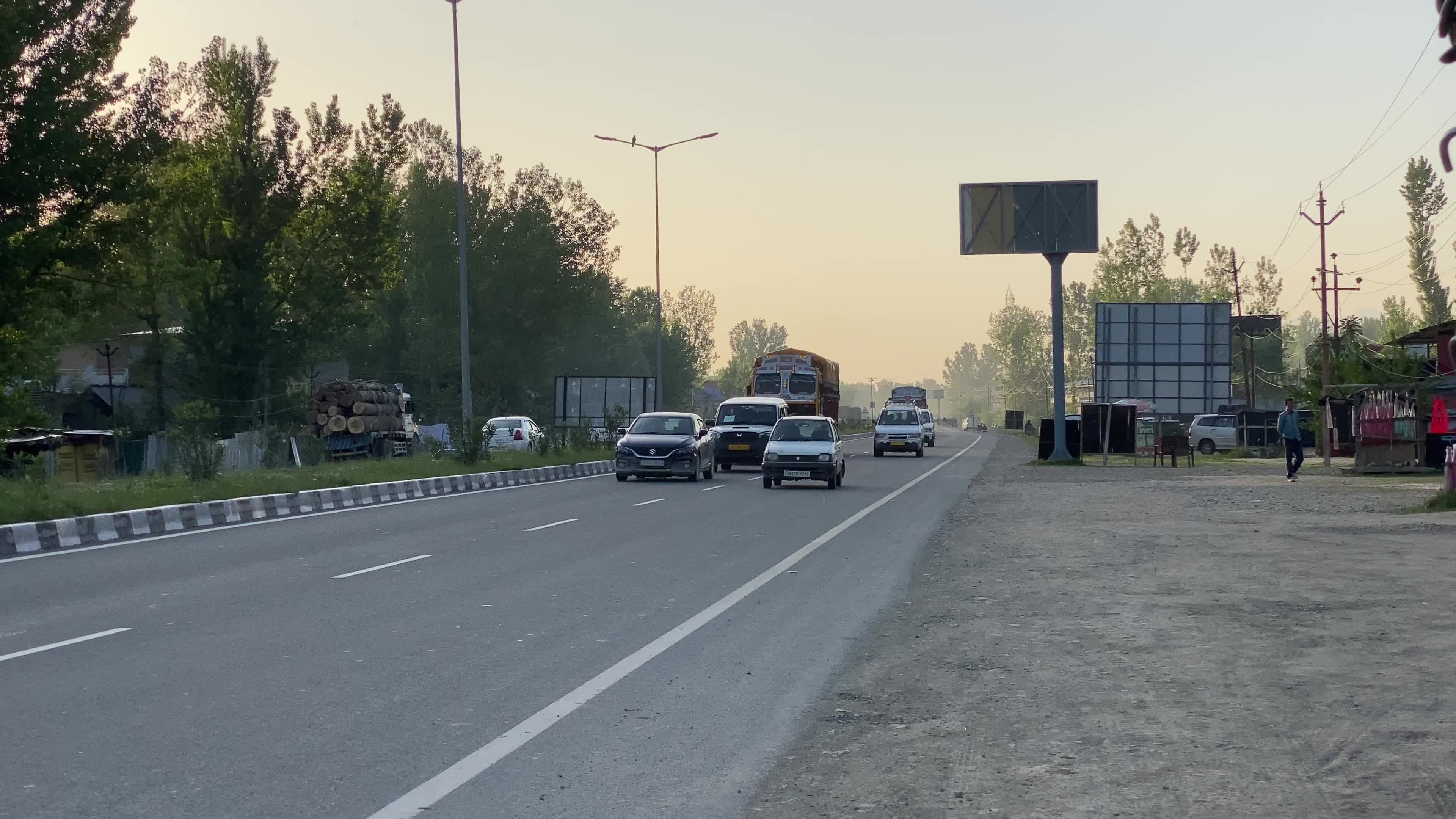 Vehicles move on National Highway (NH-44) in Srinagar on a sunny summer day