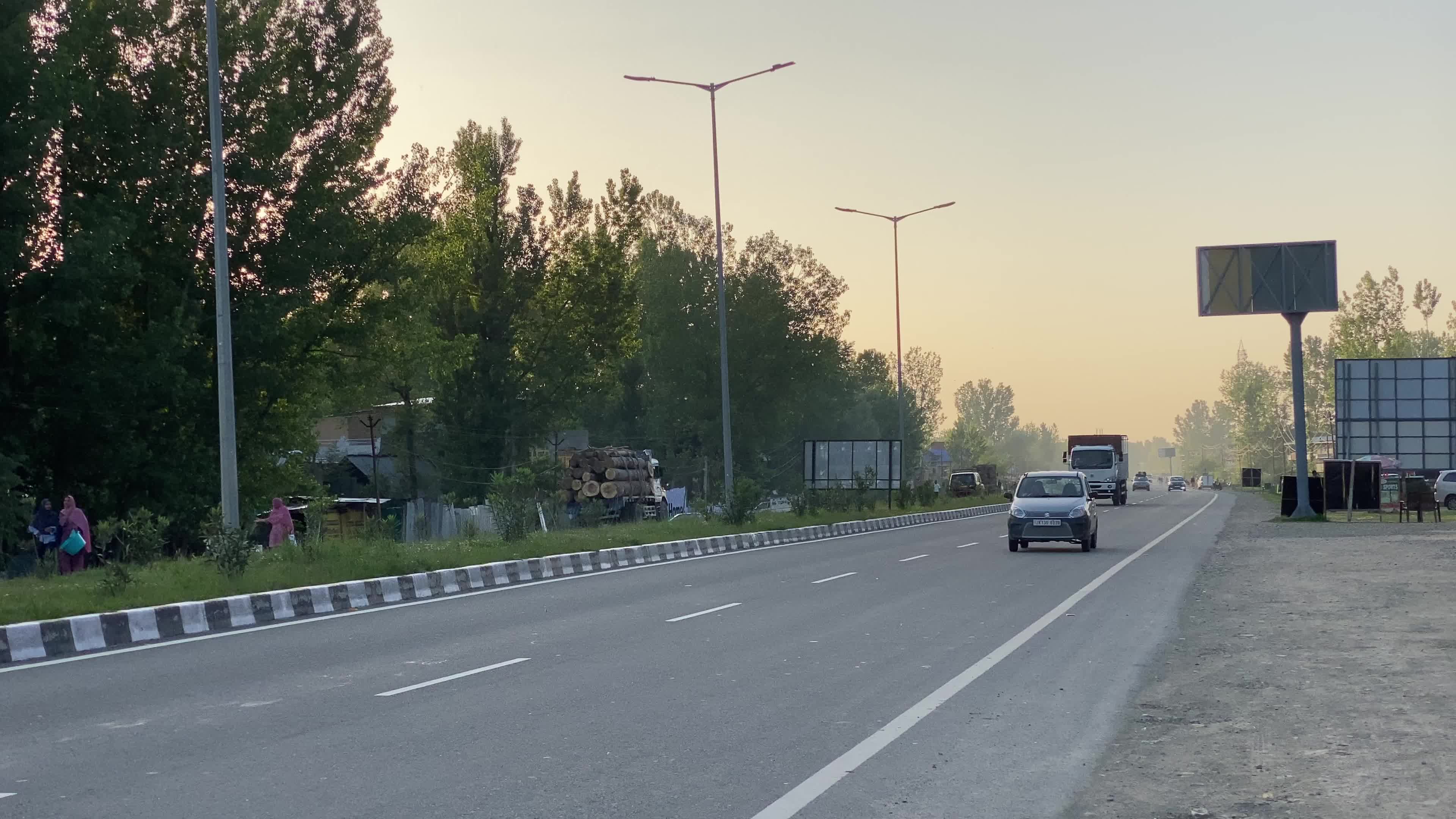 Vehicles move on National Highway (NH-44) in Srinagar on a sunny summer day