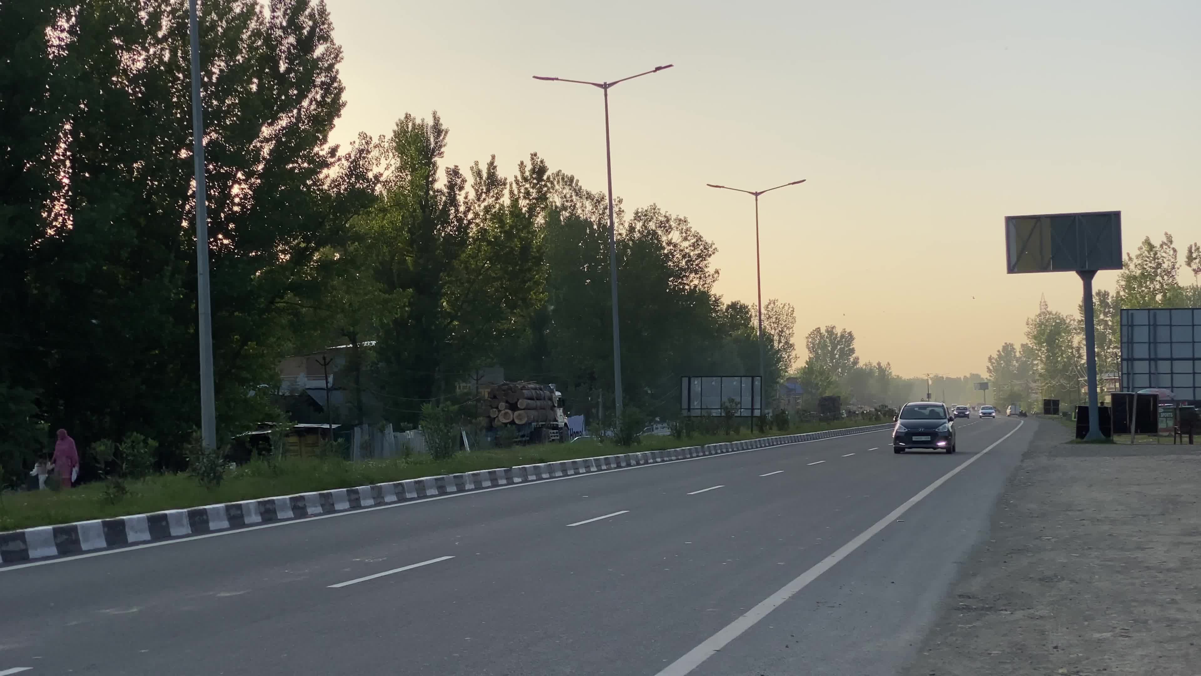 Vehicles move on National Highway (NH-44) in Srinagar on a sunny summer day