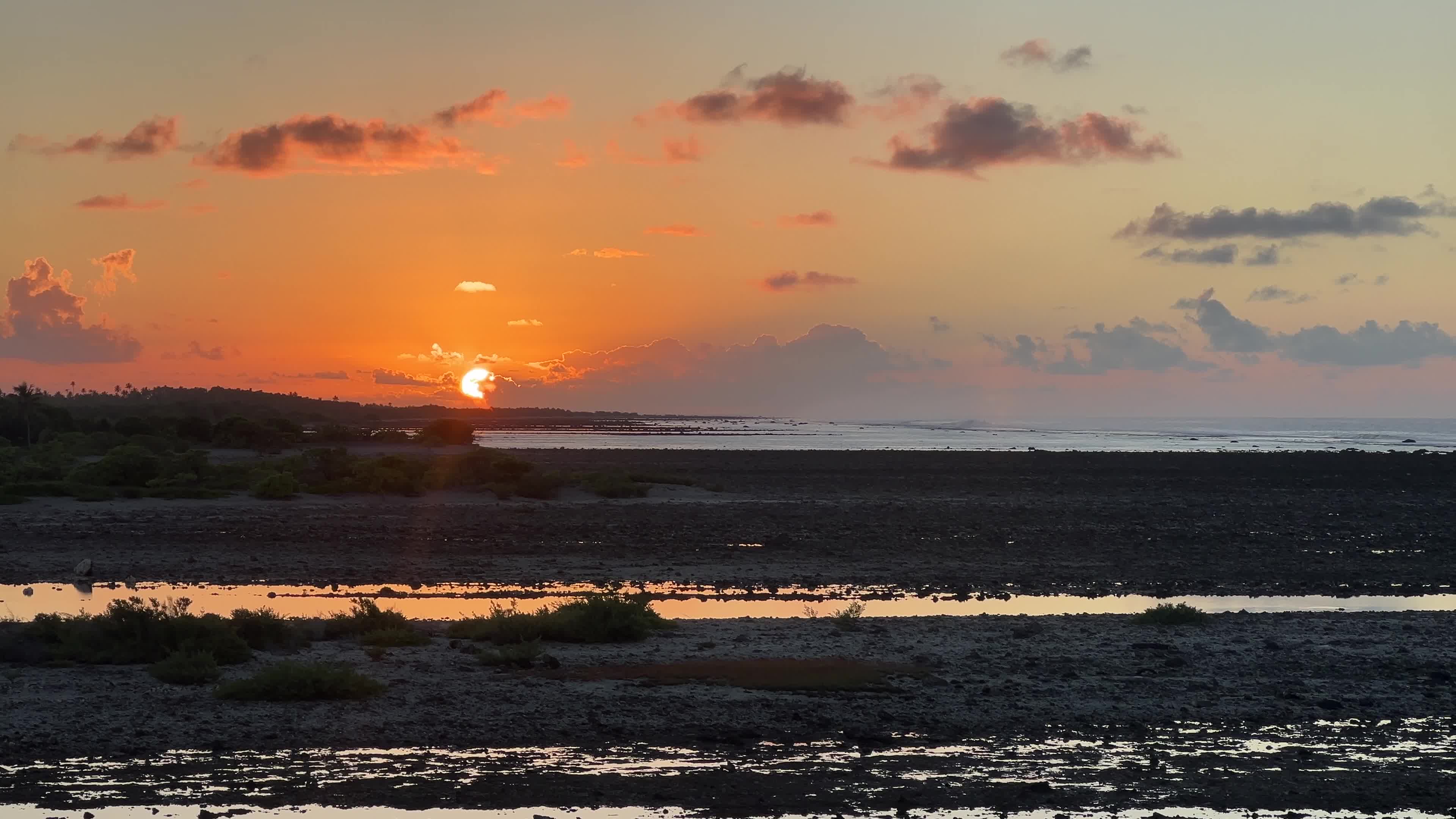 Sunrise over a coral reef in Tikehau