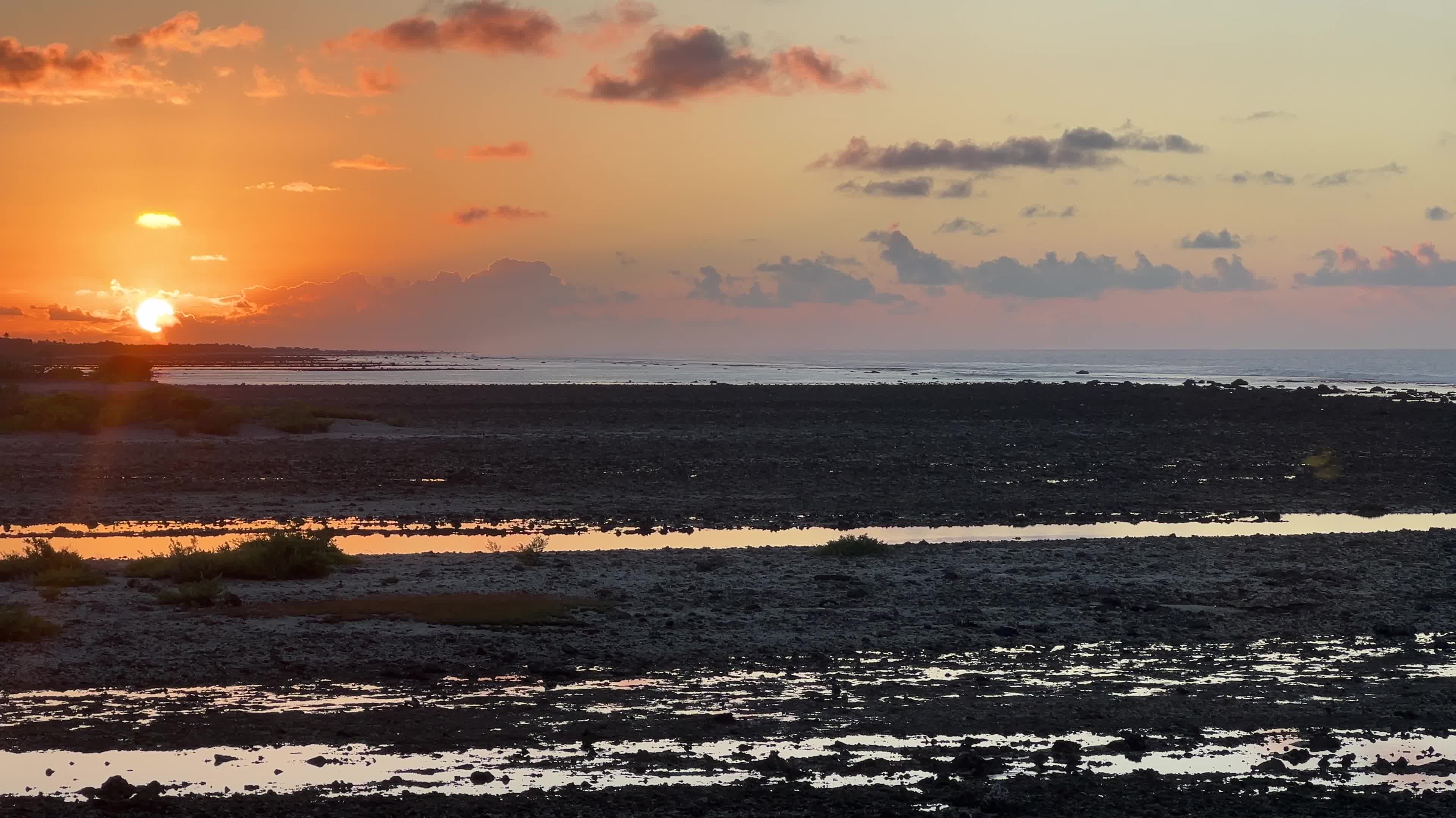 Sunrise over a coral reef in Tikehau