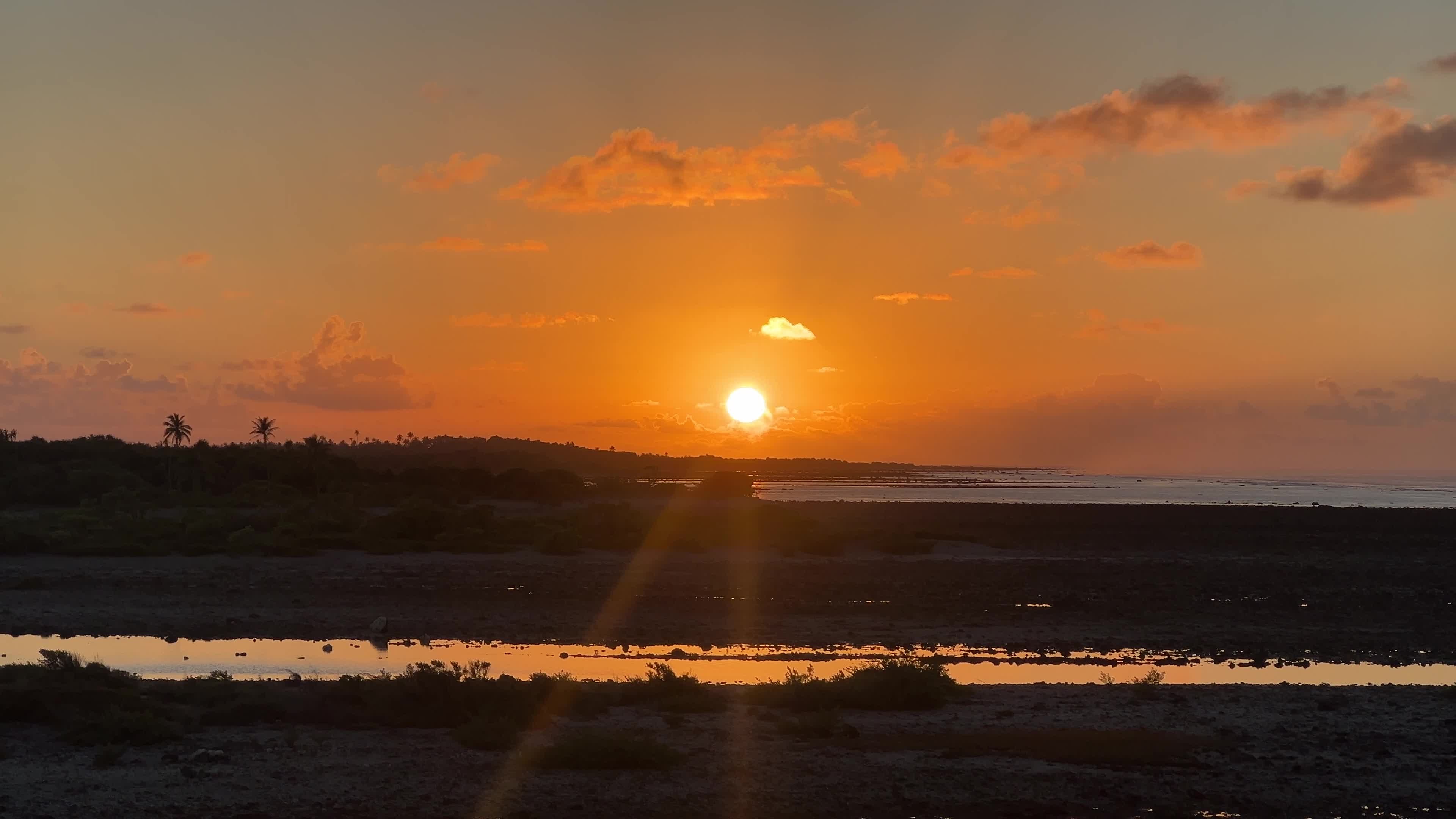 Sunrise over a coral reef in Tikehau