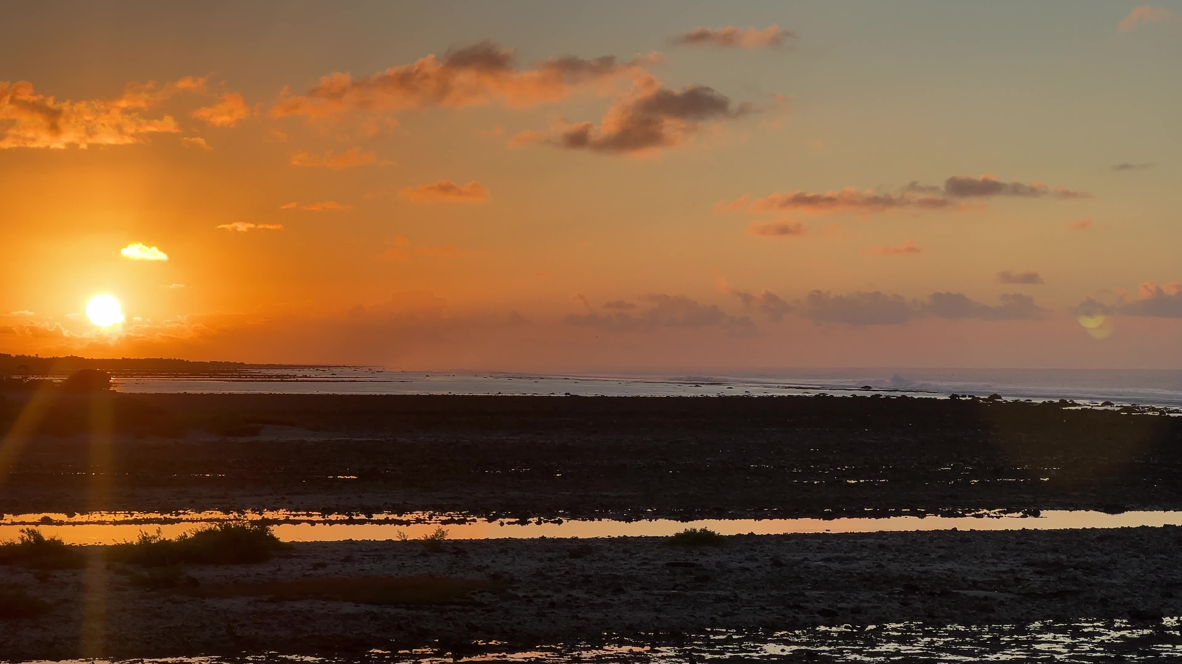 Sunrise over a coral reef in Tikehau