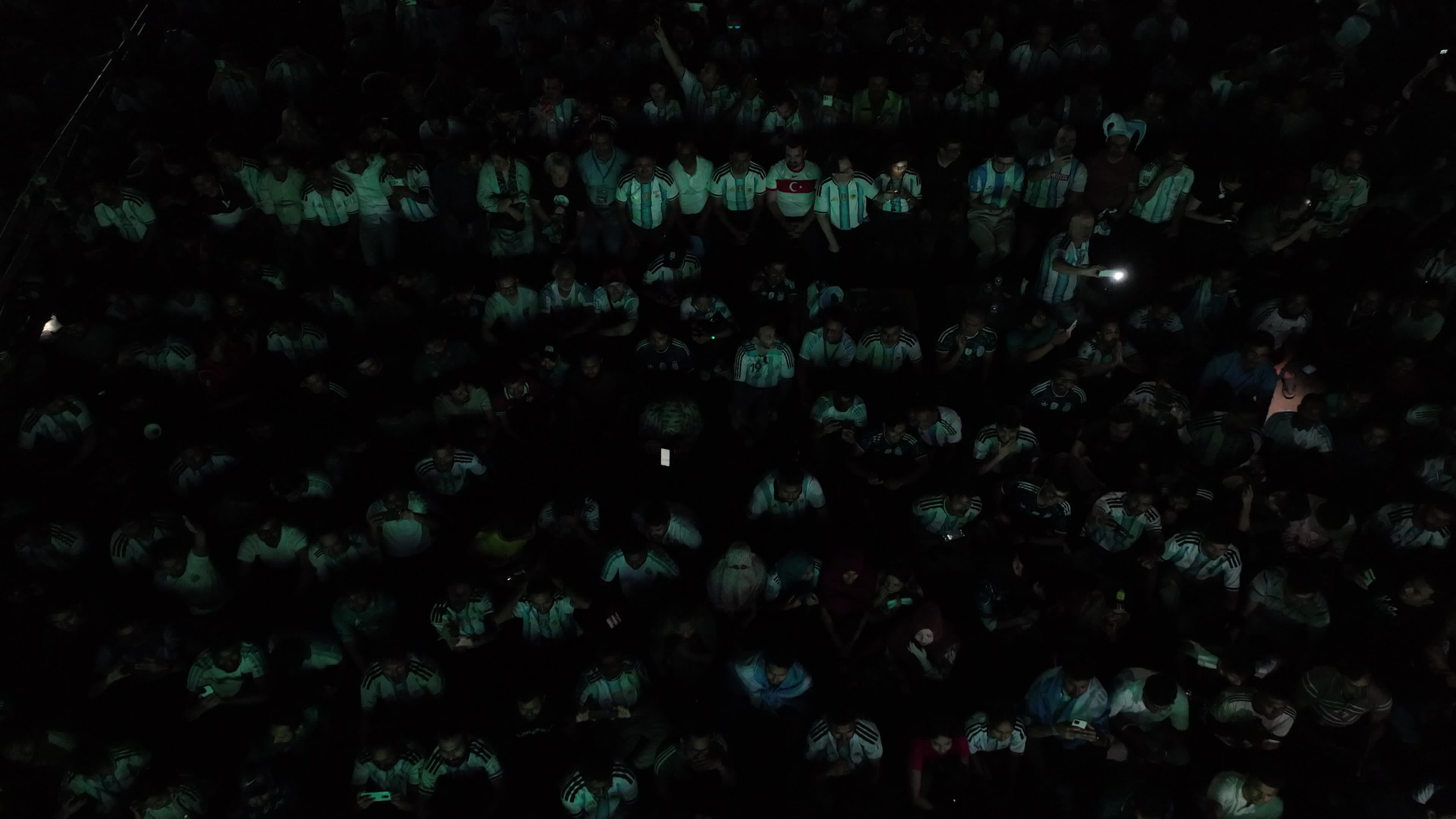 Aerial view of Argentina football fans watching a FIFA World Cup match between Argentina and Austria on a giant screen in the Dhaka University