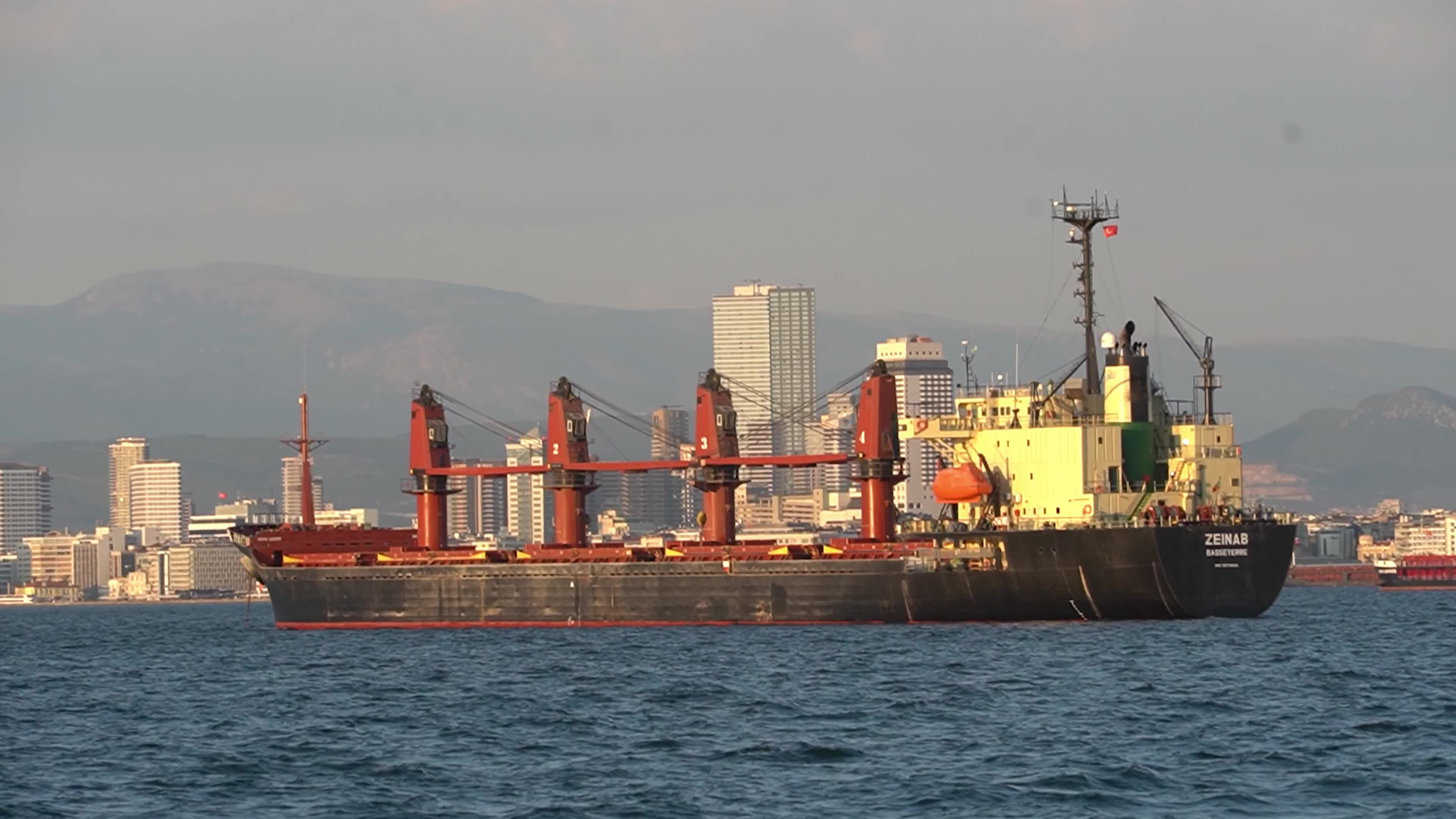 A large commercial bulk carrier cargo ship anchored in the Gulf of Izmir