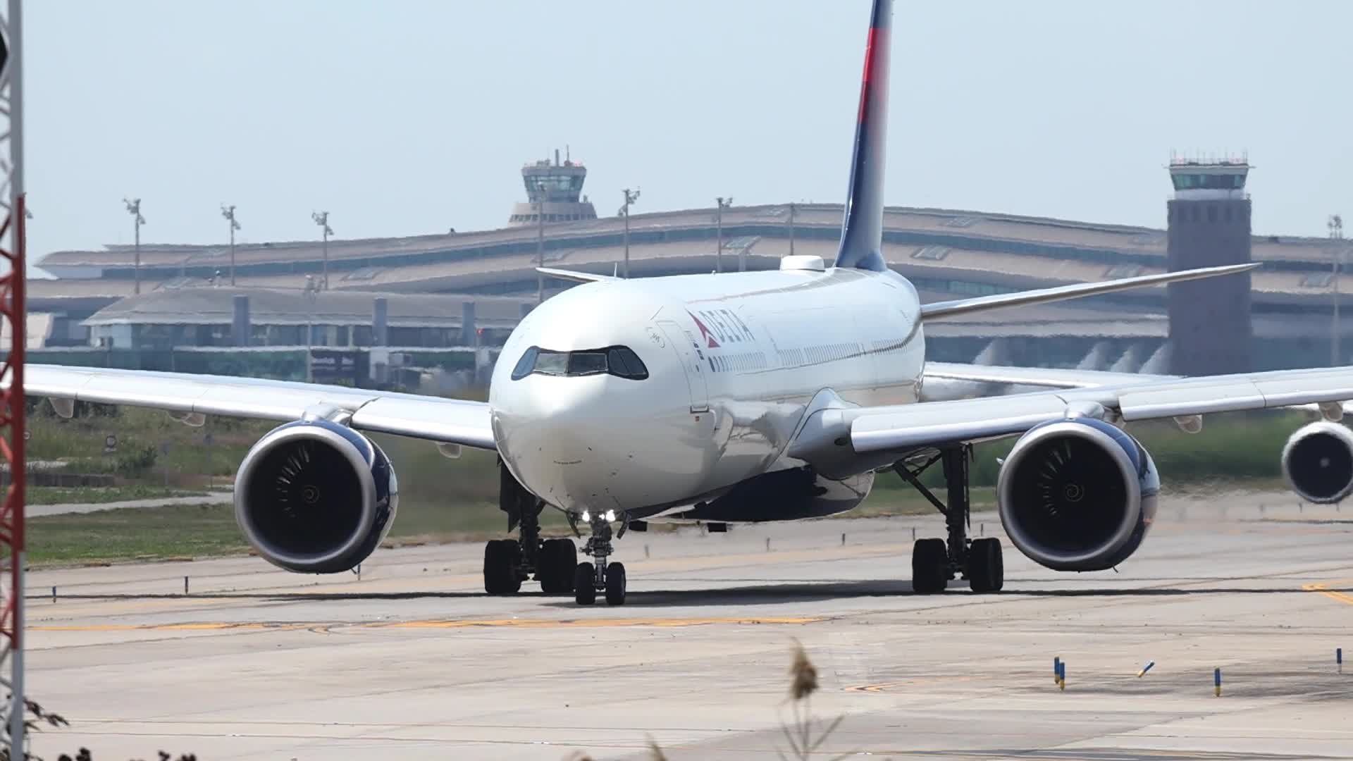 Delta Air Lines and LEVEL aircraft take off from Barcelona Airport