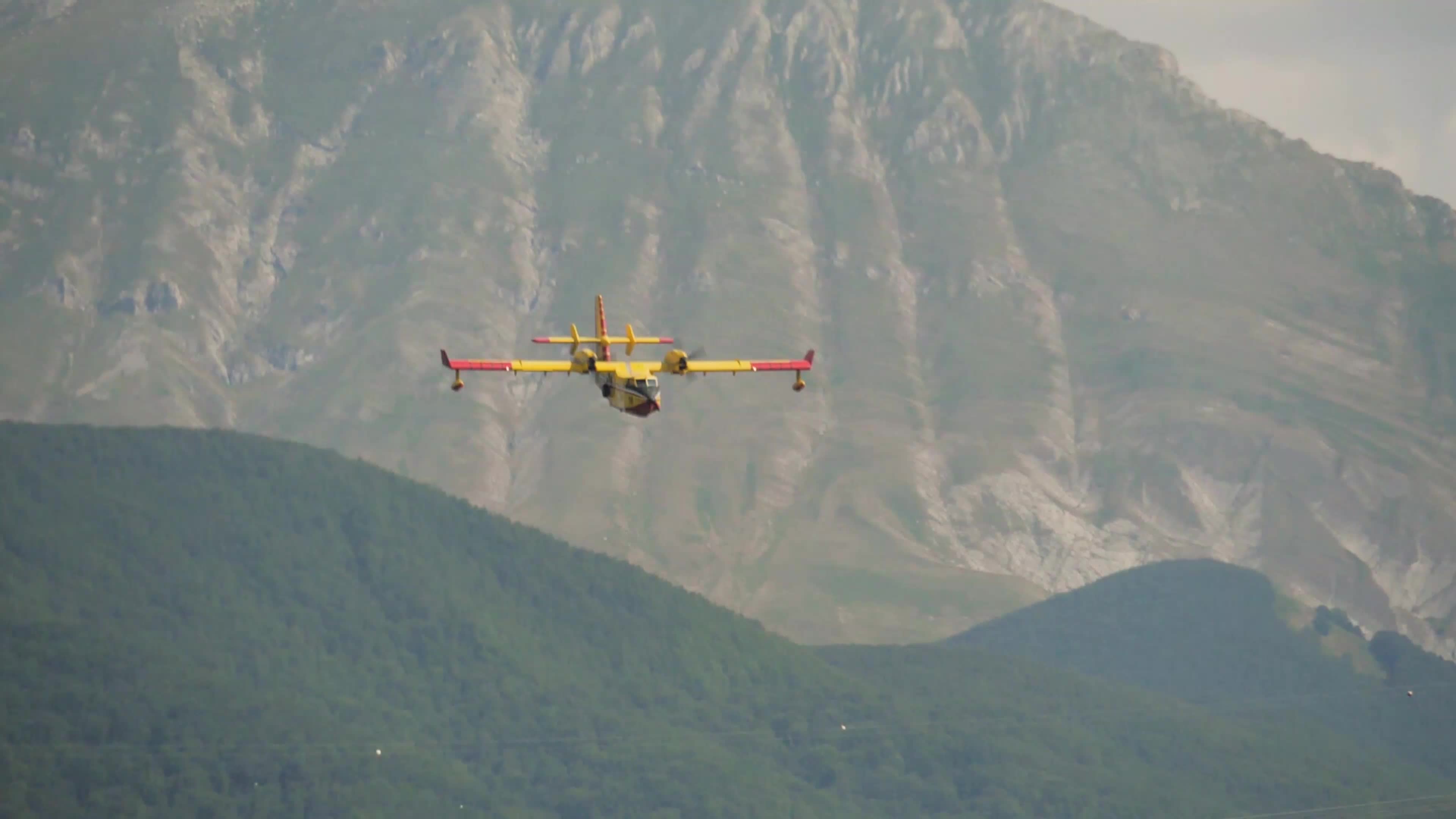 Amphibious firefighting aircraft scooping water from the Campotosto Lake - Italy