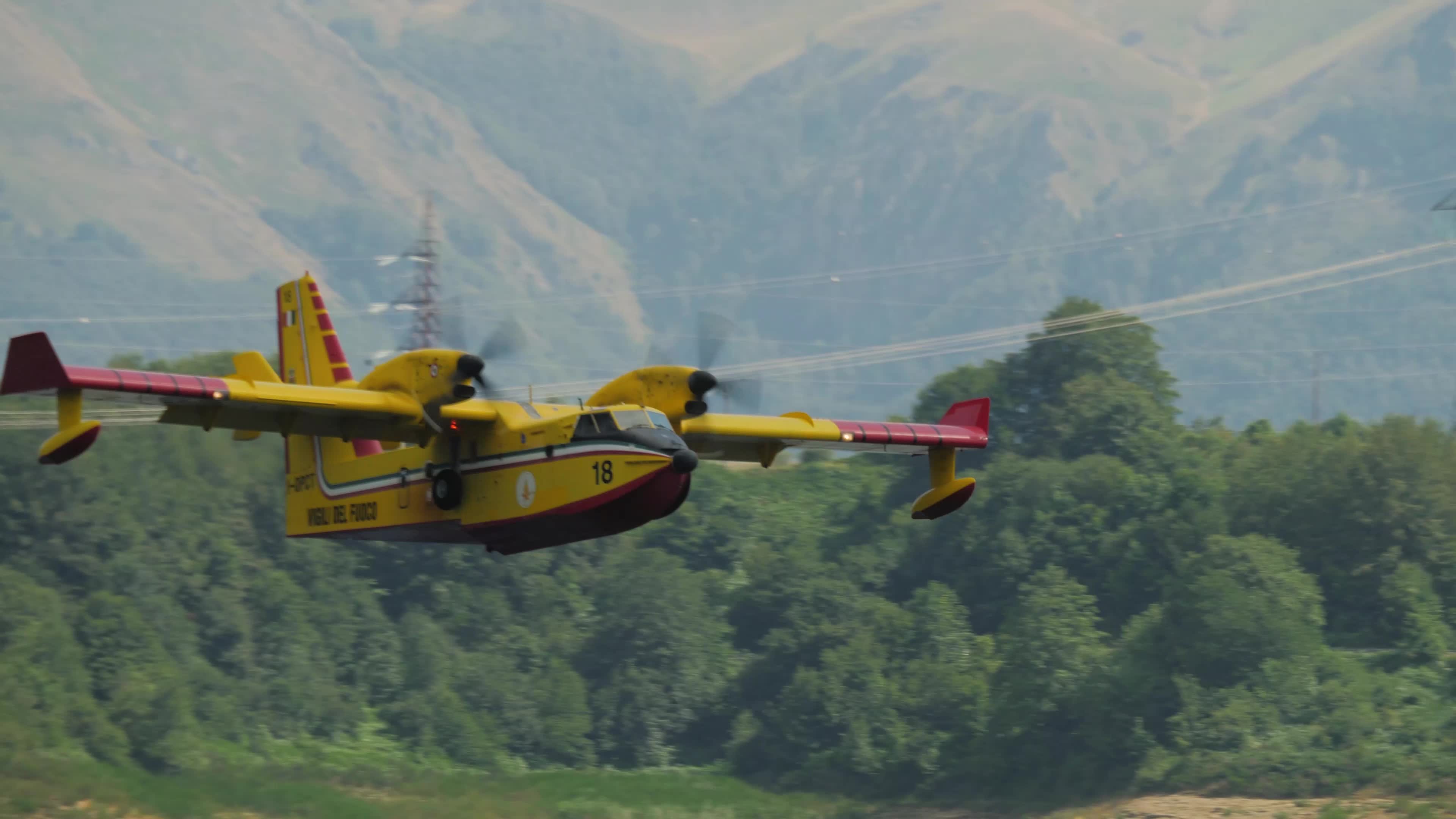 Amphibious firefighting aircraft scooping water from the Campotosto Lake - Italy