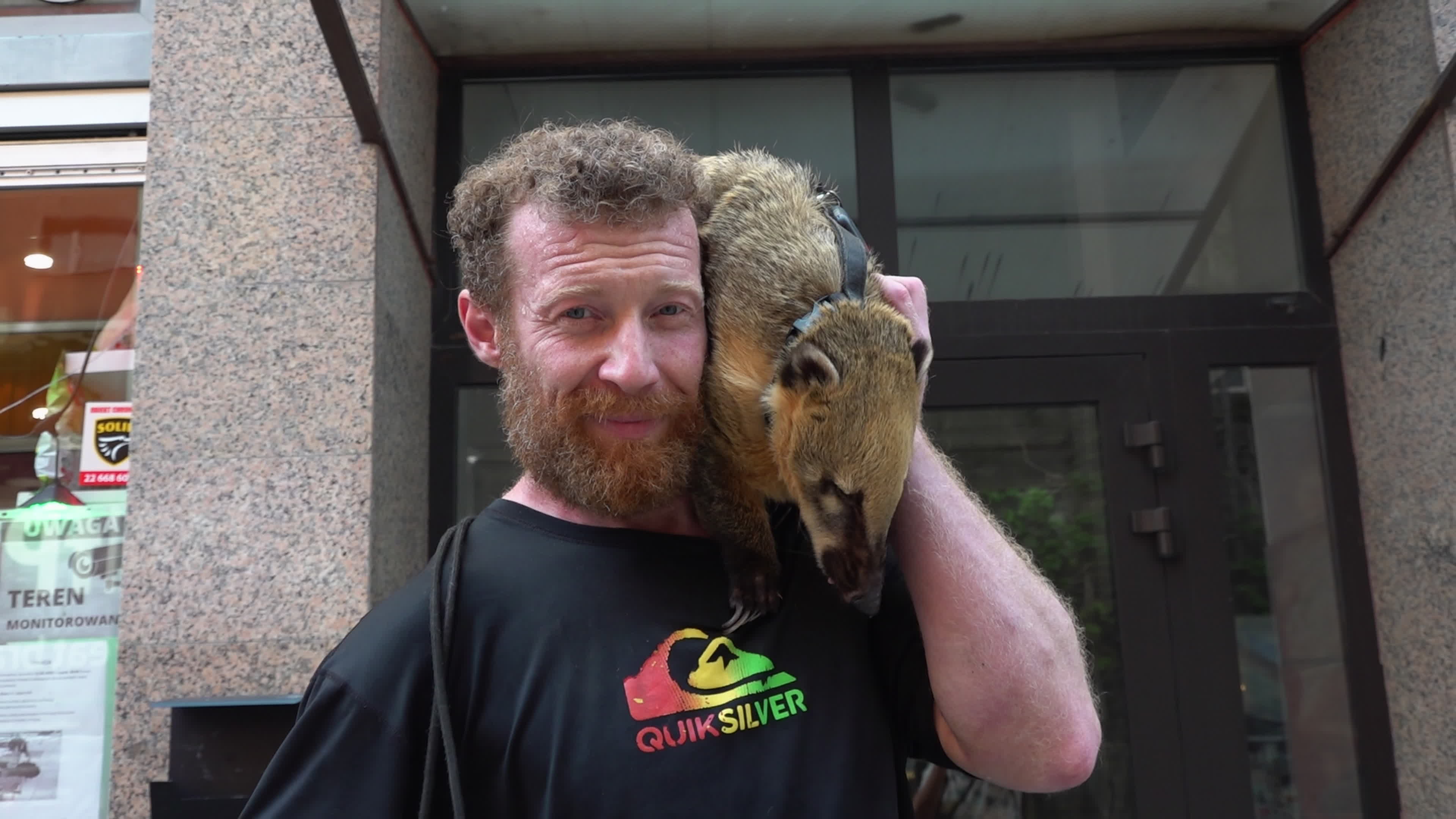Exotic Pet Draws Crowds as Man Walks Coati and Dog in Central Warsaw