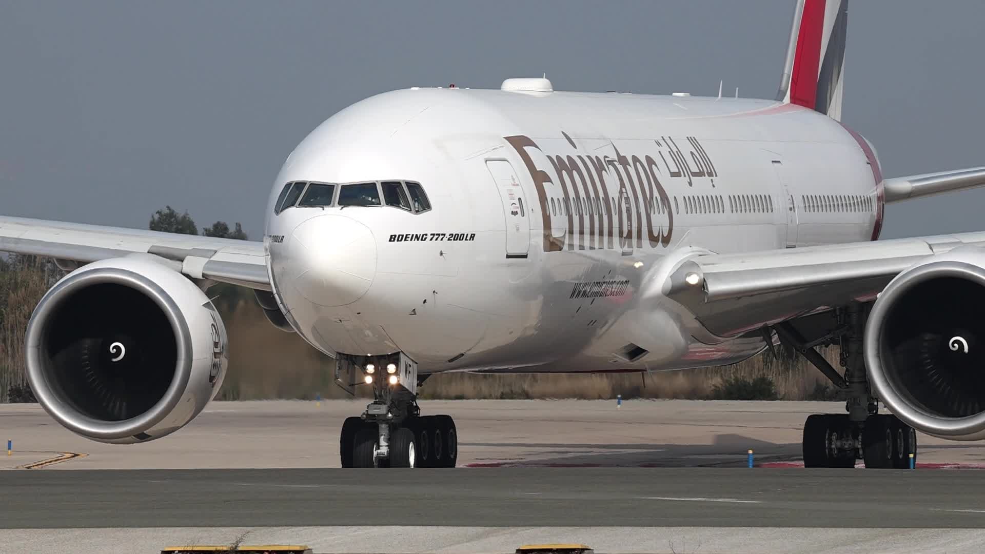Emirates and United Airlines aircraft take off from Barcelona Airport