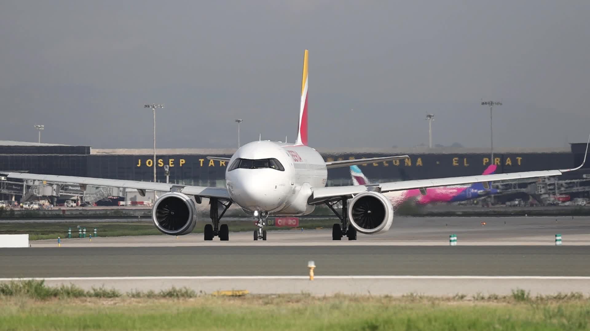 Iberia and Vueling aircraft maneuvering at Barcelona Airport