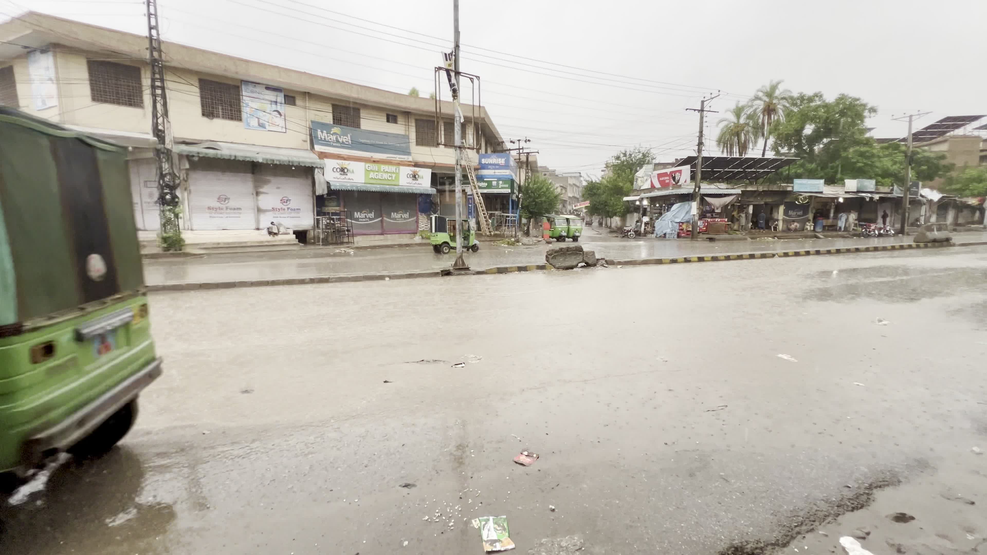 Vehicles make their way through heavy monsoon rain in Peshawar