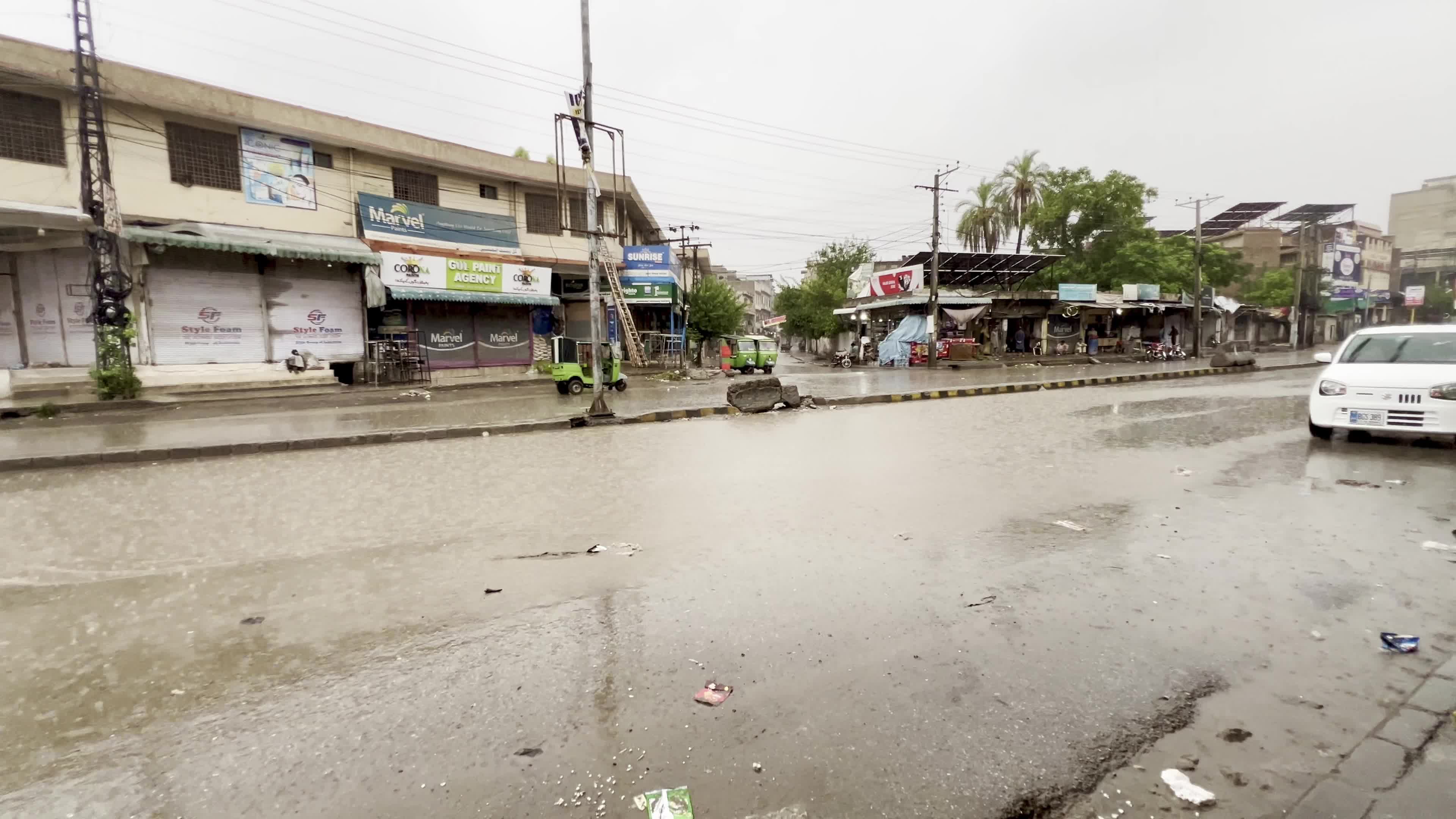 Vehicles make their way through heavy monsoon rain in Peshawar