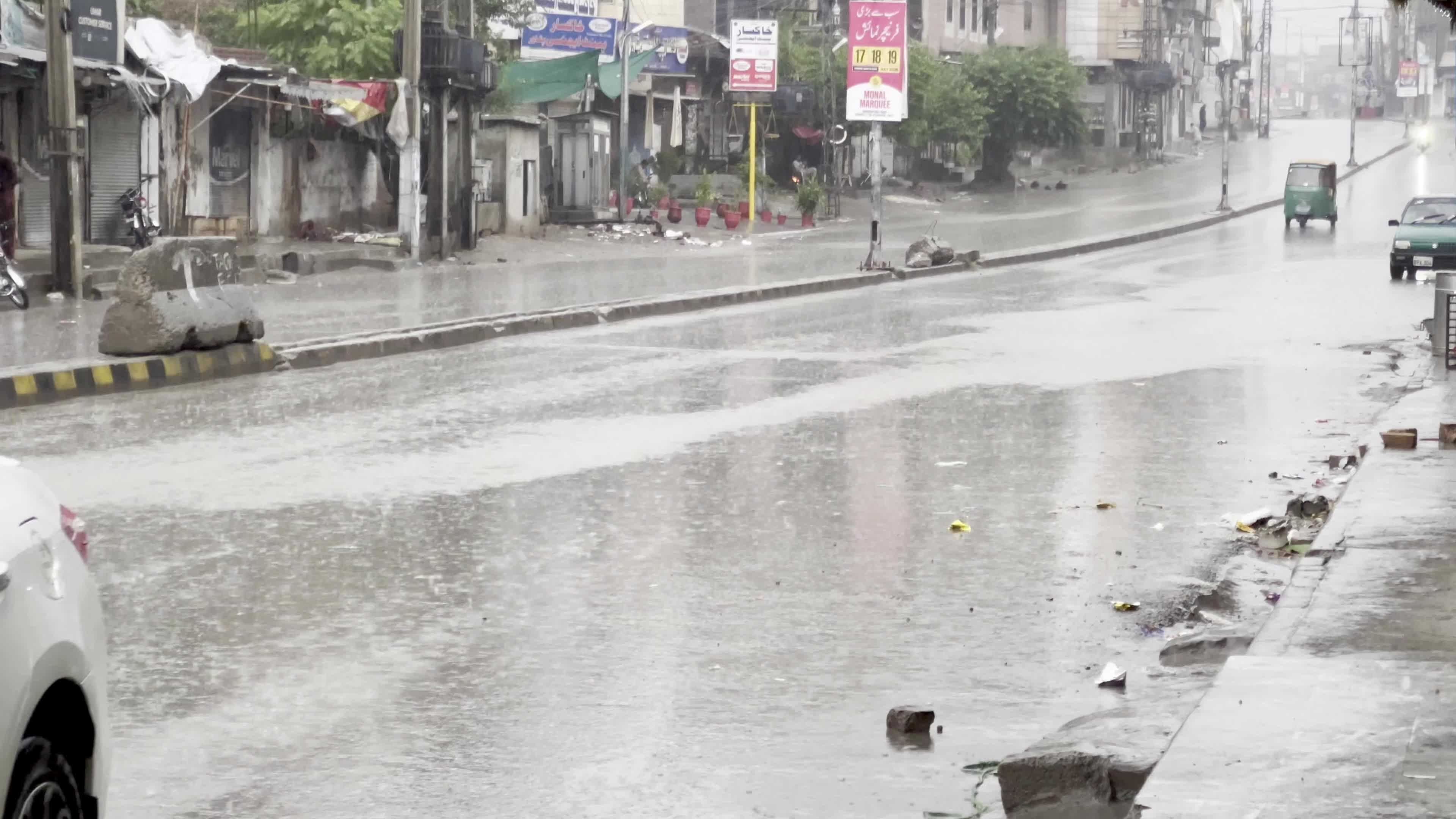 Vehicles make their way through heavy monsoon rain in Peshawar