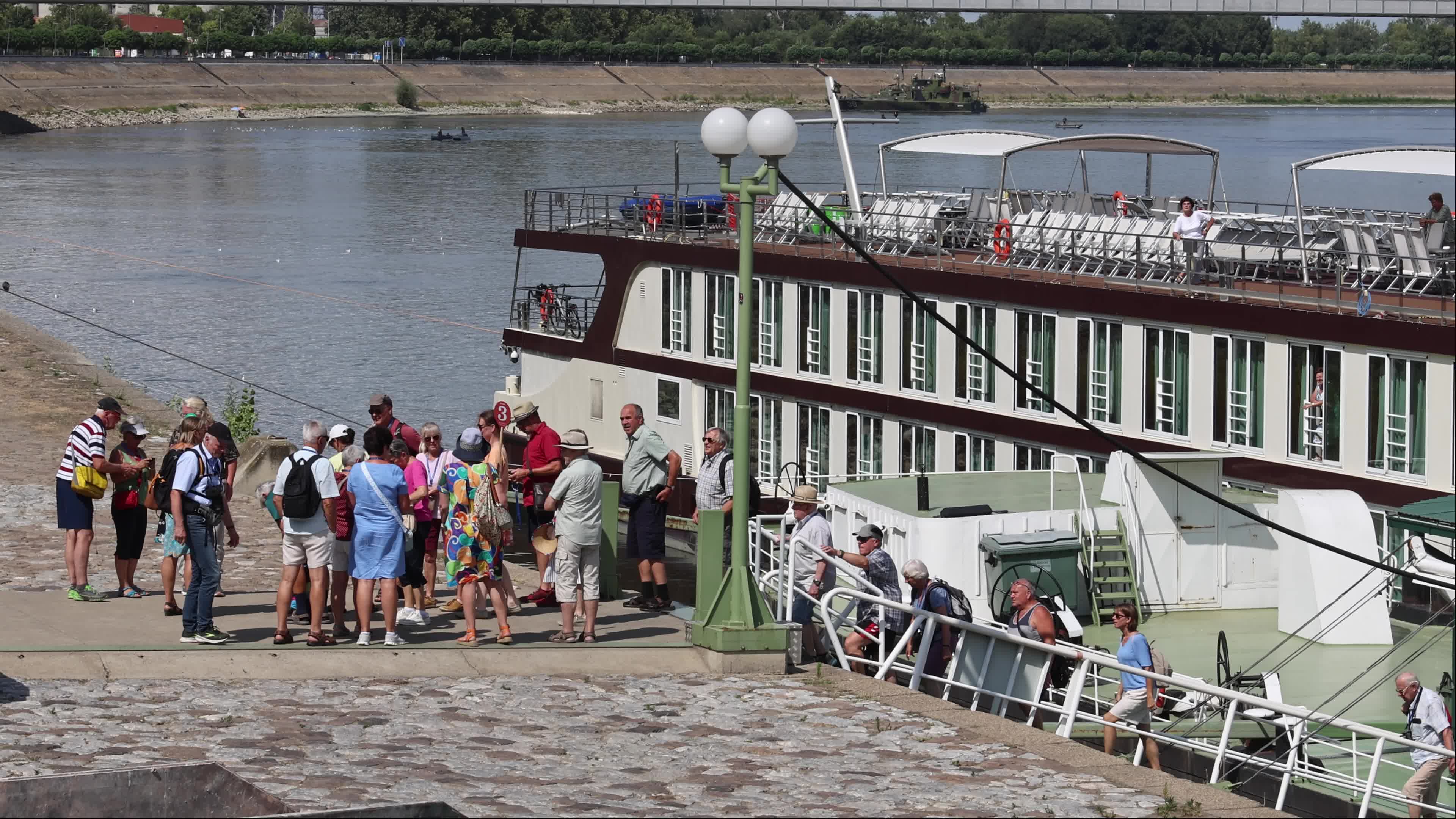 Tourists disembark from a river cruise ship