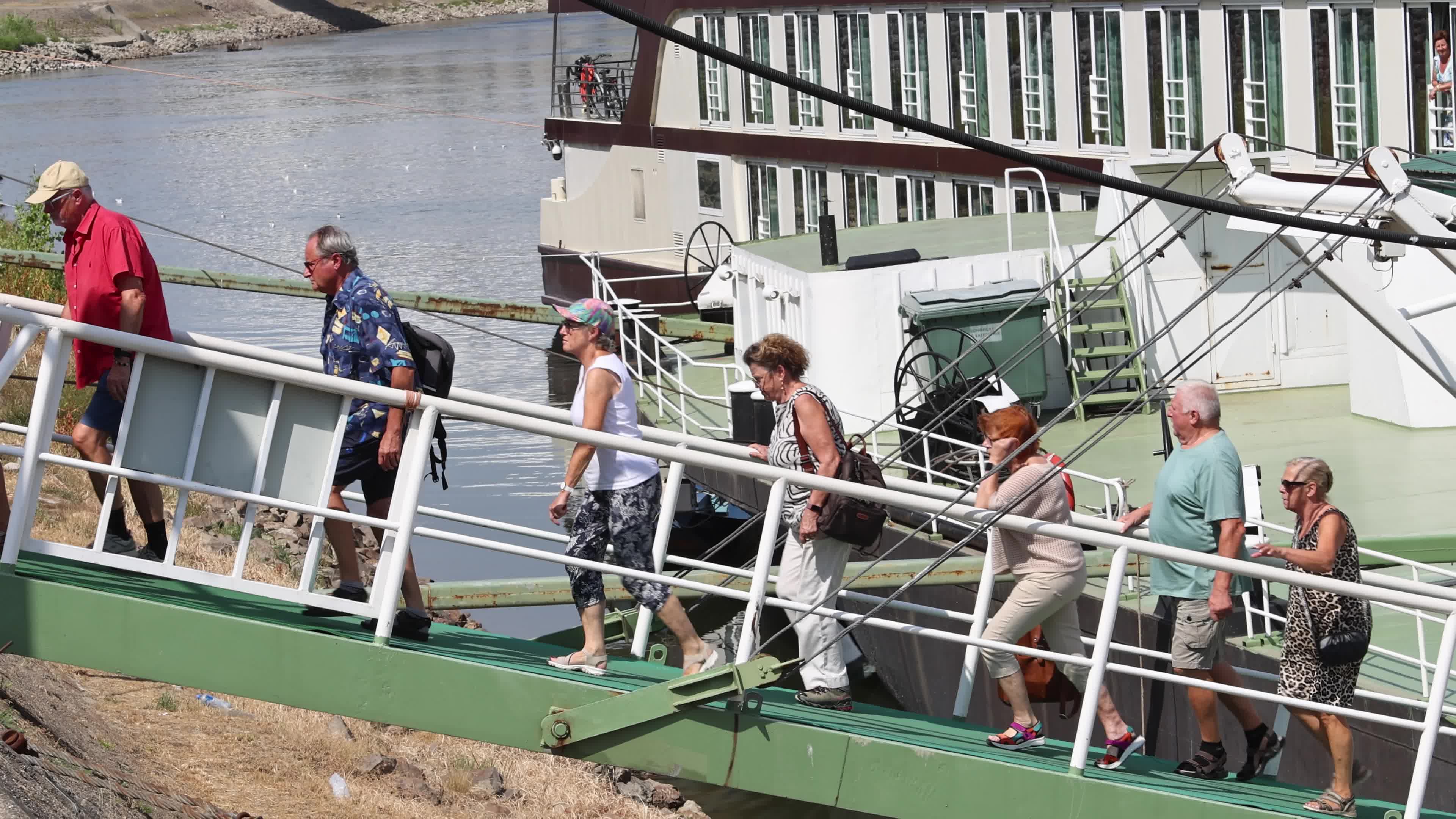 Tourists disembark from a river cruise ship