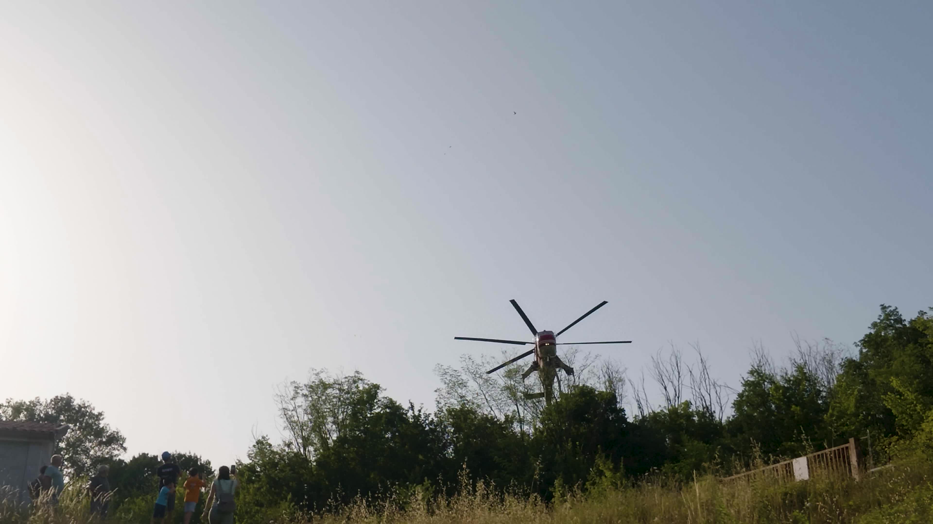 Italian Fire Brigade Erickson S-64 Helitanker Scooping Water From Lake for Firefighting Operations.