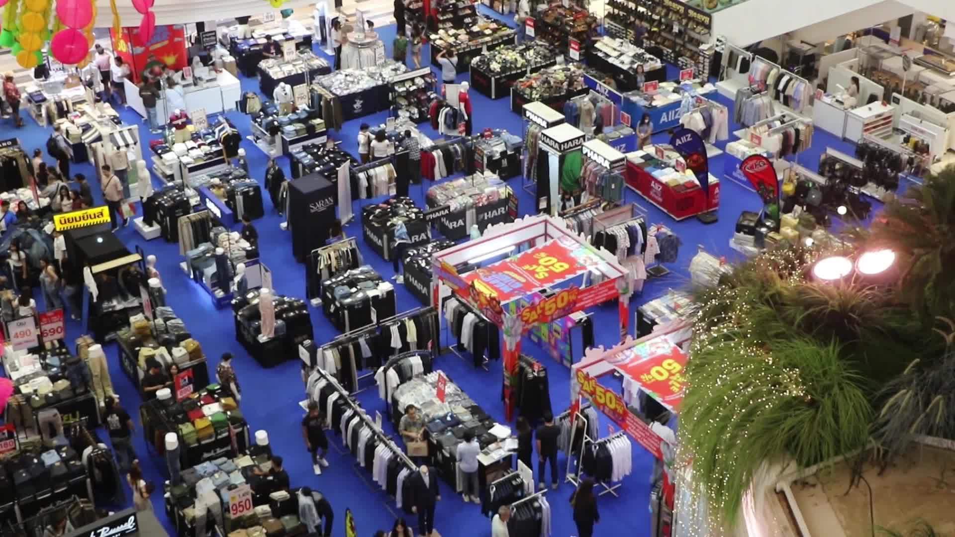 Tourists walk as they shop in the shopping mall in Bangkok.