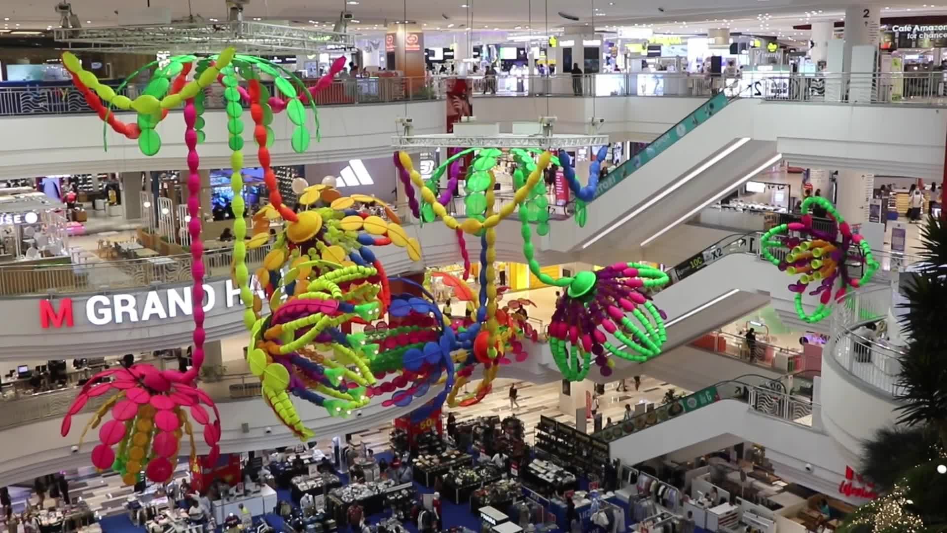 Tourists walk as they shop in the shopping mall in Bangkok.