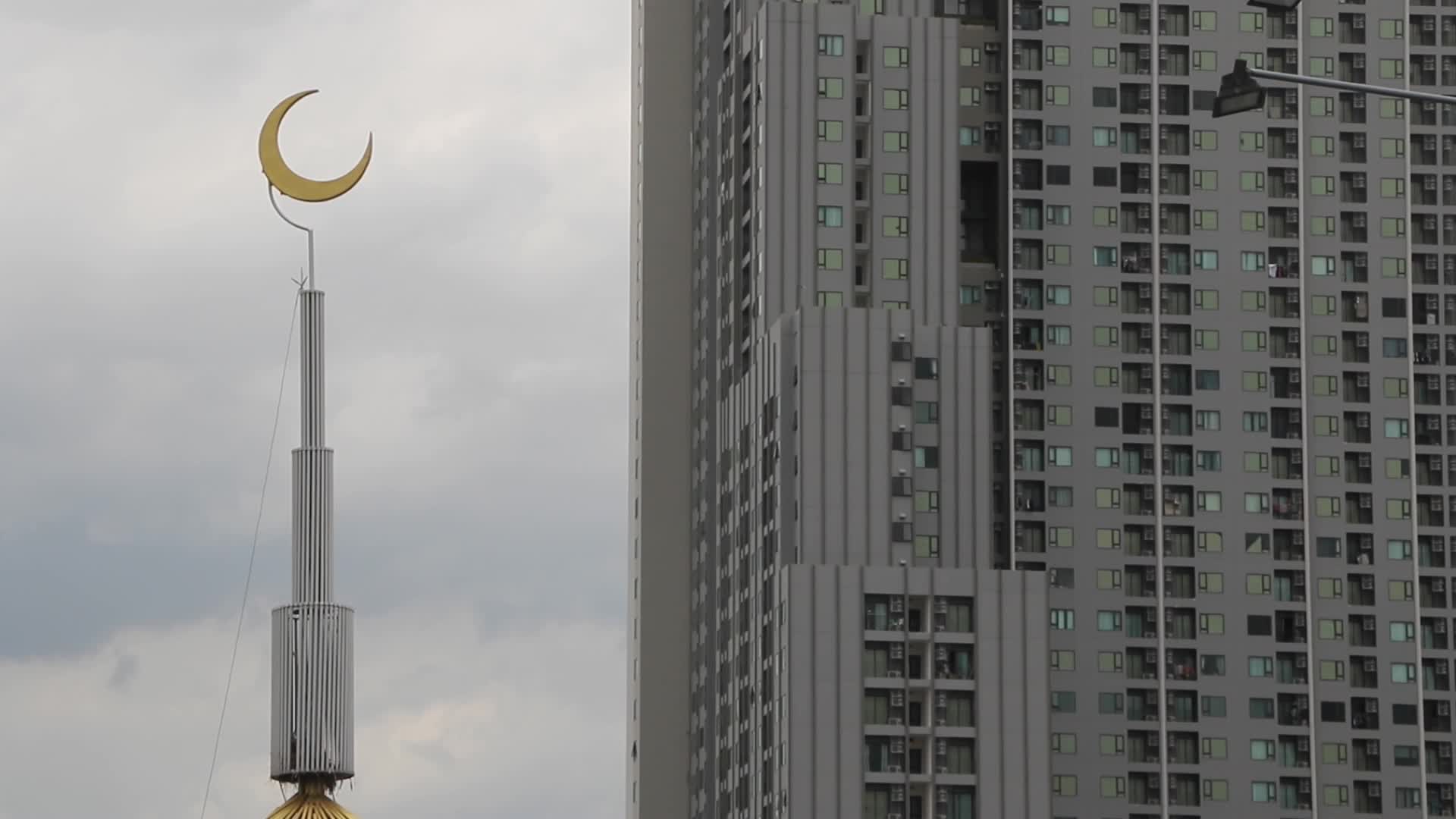 Hilal islam symbol stands next to modern building