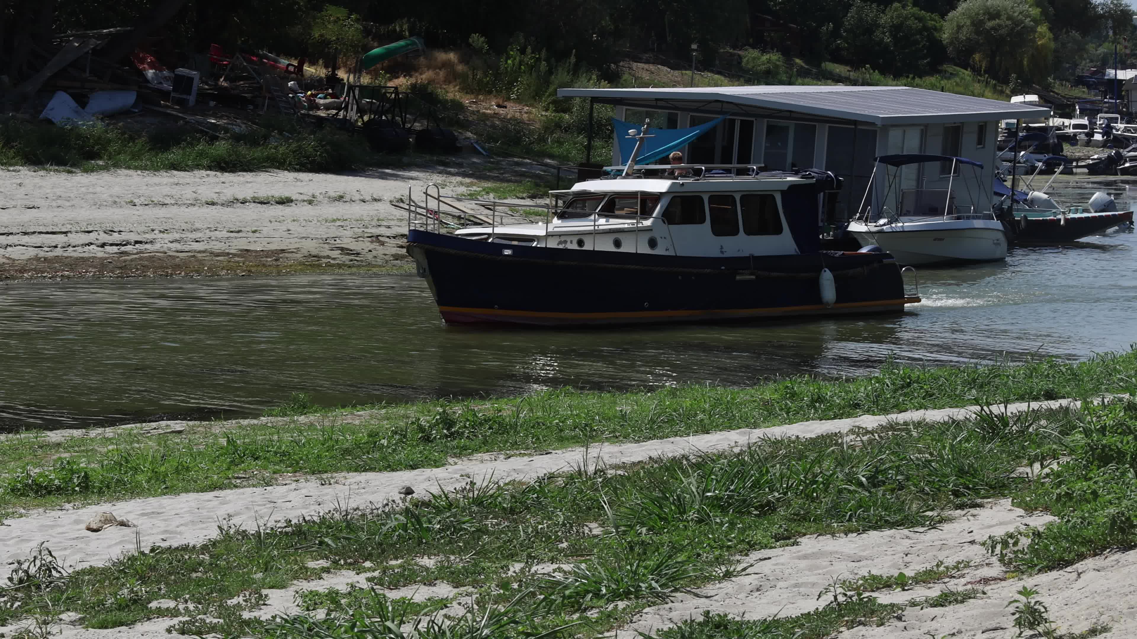 Cabin Cruiser Navigates Shallow Water in Novi Sad