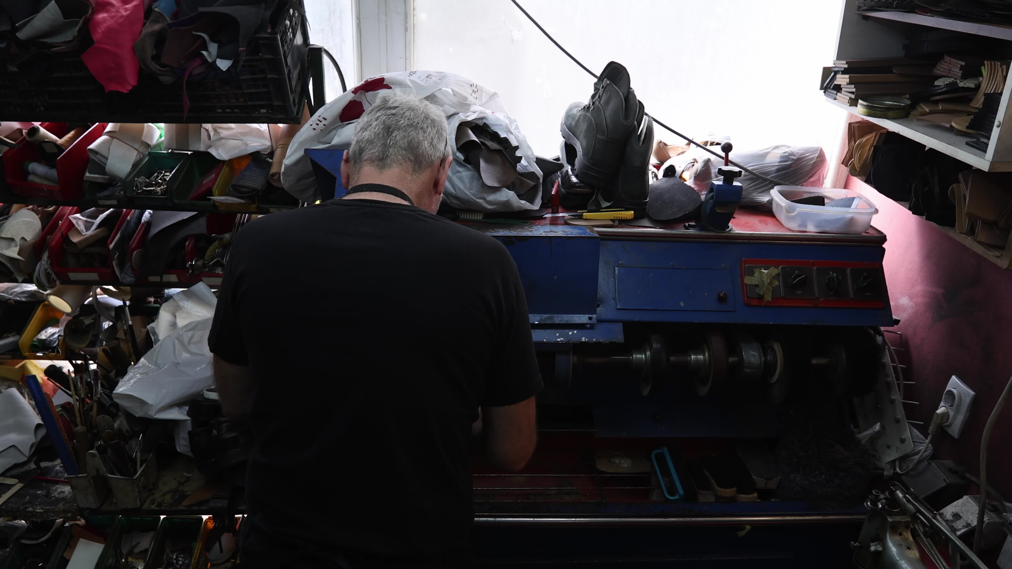 Shoemaker Working on a Grinding Machine in His Workshop