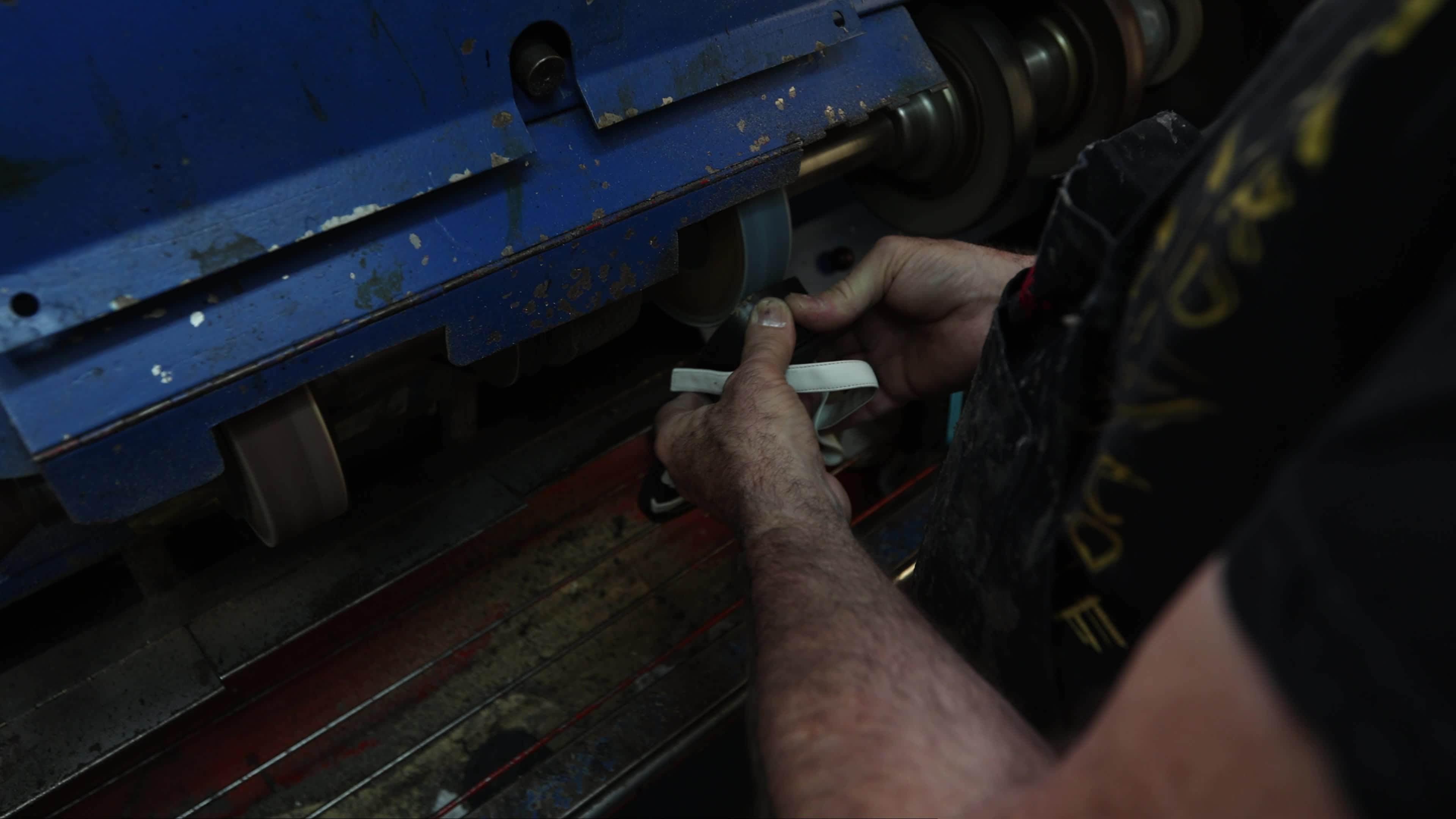 Shoemaker Working on a Grinding Machine in His Workshop