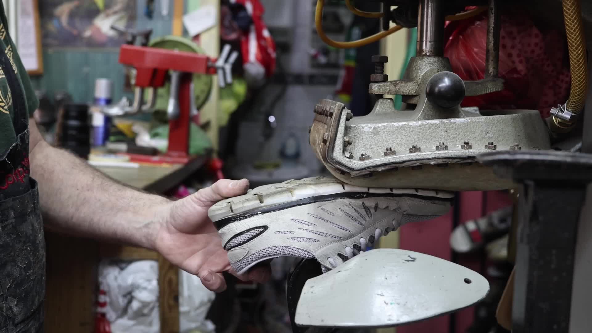 Shoemaker Working on a Press Machine in His Workshop