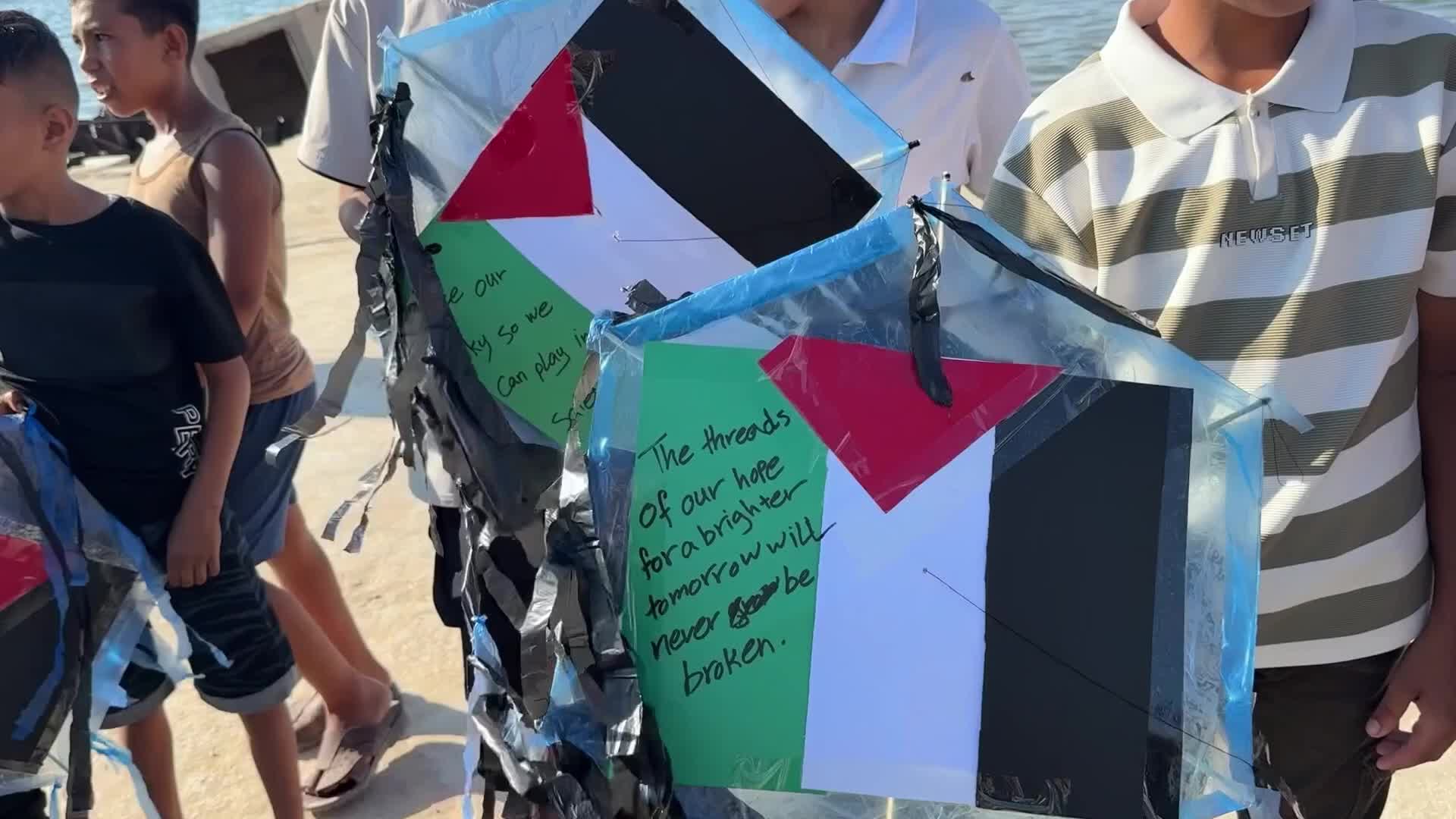 Palestinian children hold kites during a gathering at Gaza Port on August 25, 2026.
