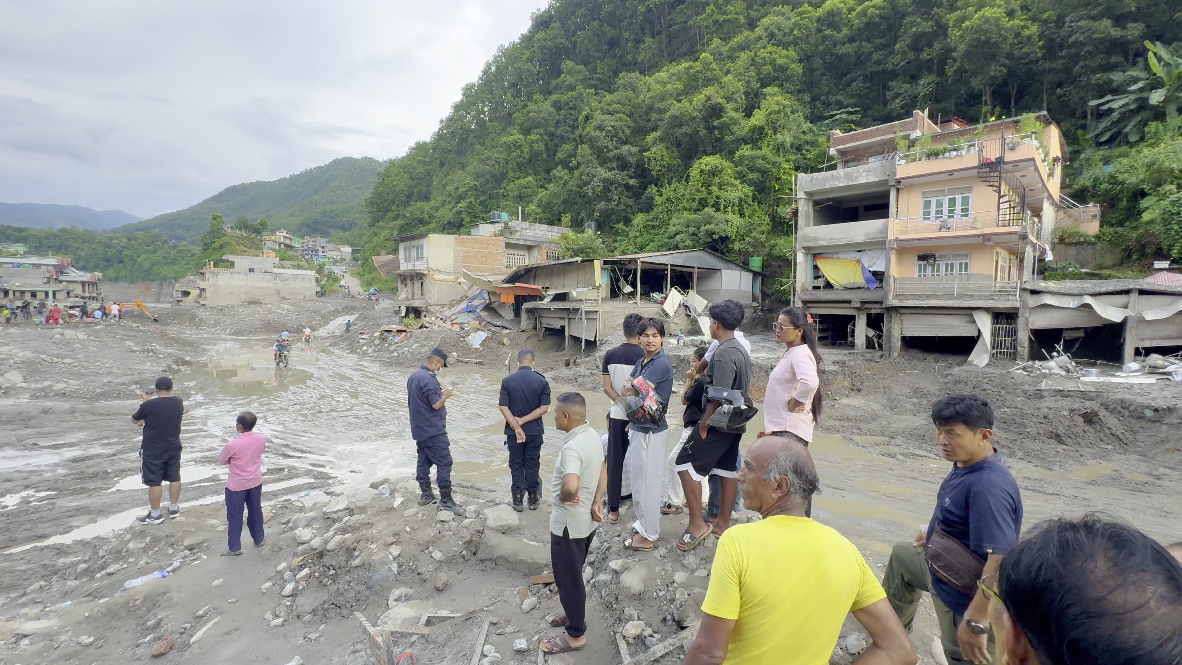 NEPAL: Residents and Security Personnel Survey Flood-Ravaged Settlement in Trishuli Basin