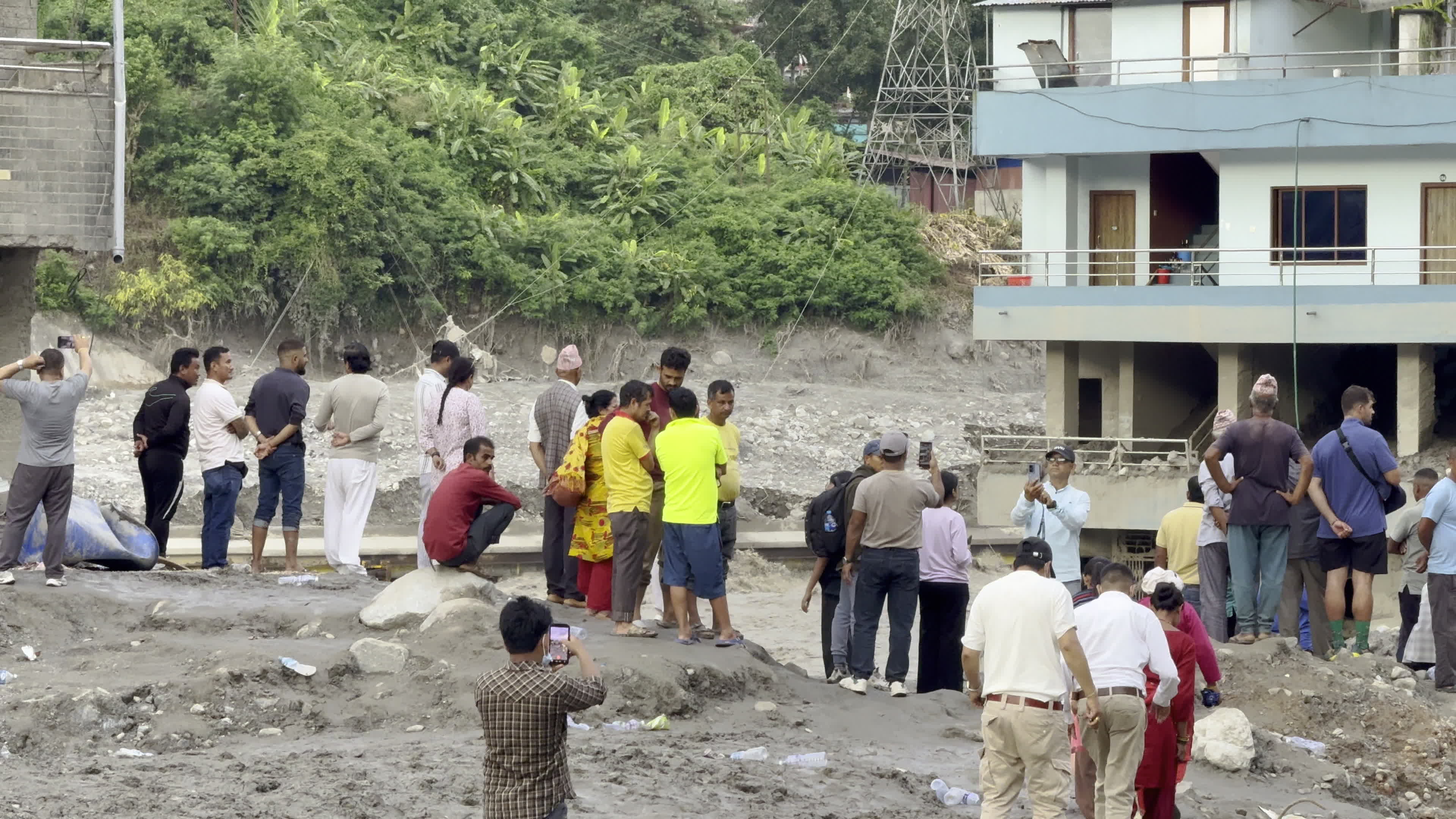 NEPAL: Crowds of Residents Gather Along Eroded Trishuli Riverbank to Witness Flood Damage