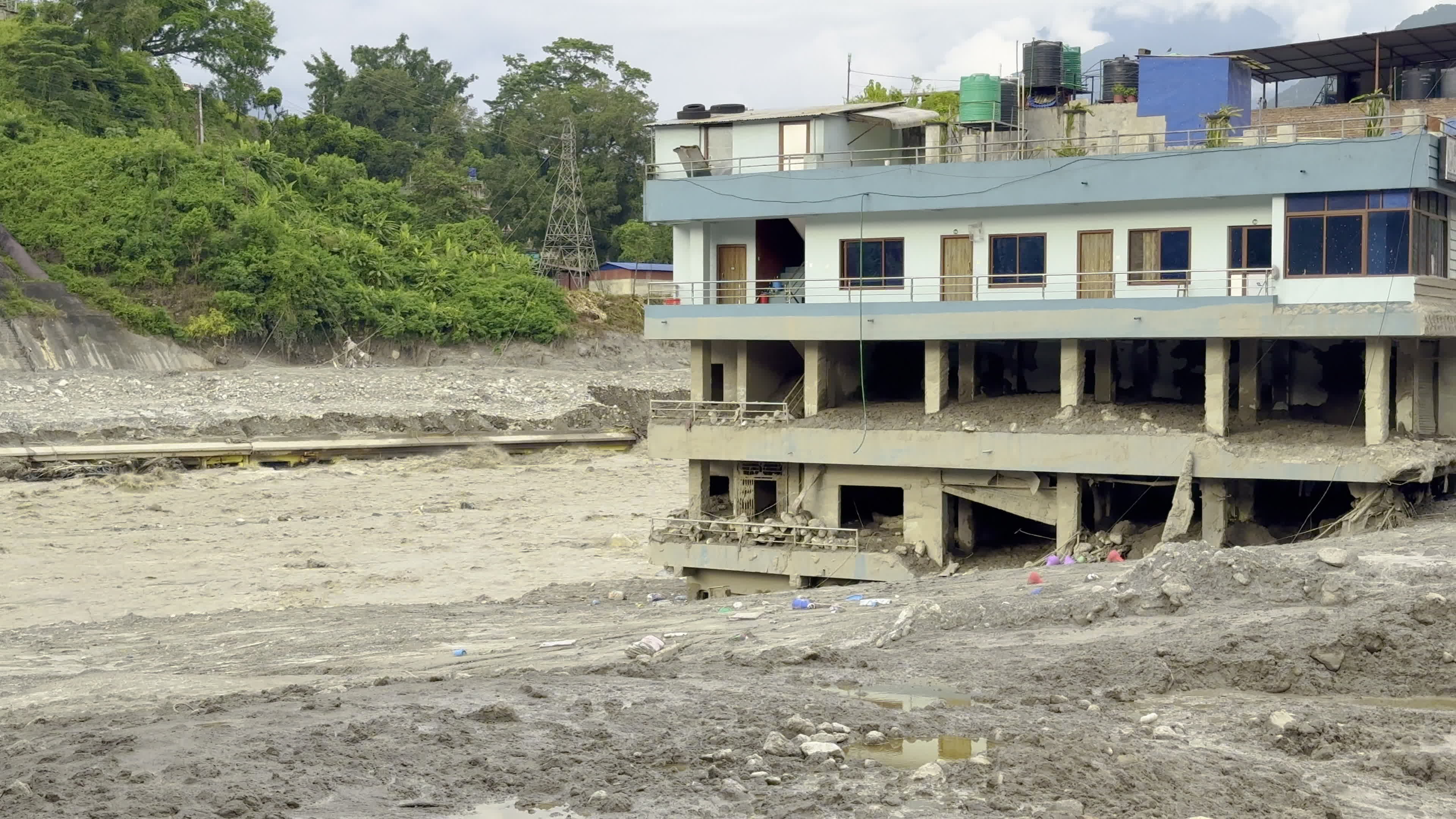 NEPAL: Multi-Story Building Submerged in Mud Along Raging Trishuli River and Hydropower Penstock