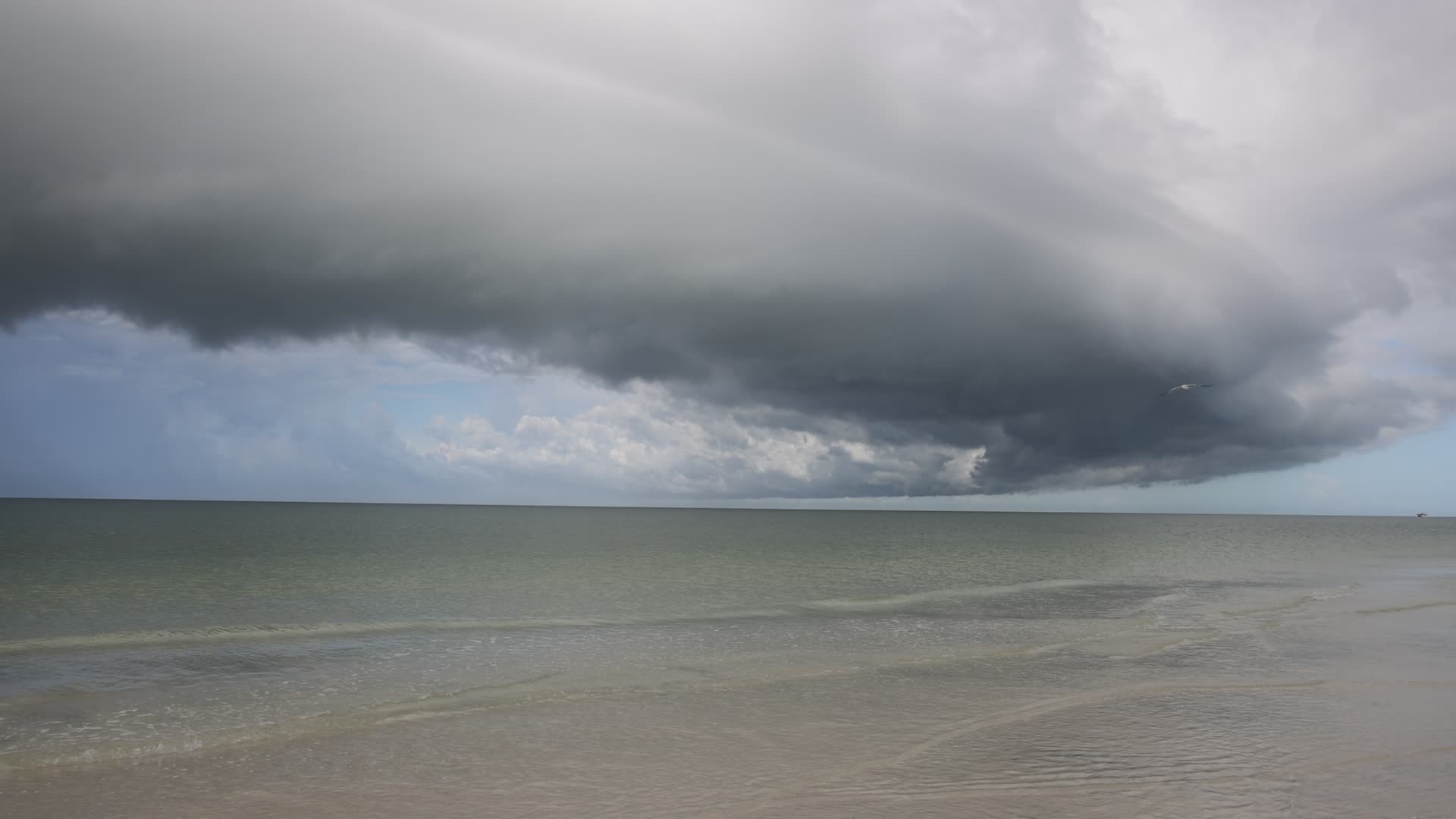 Dark thunderstorm clouds loom over Crescent Beach in Florida