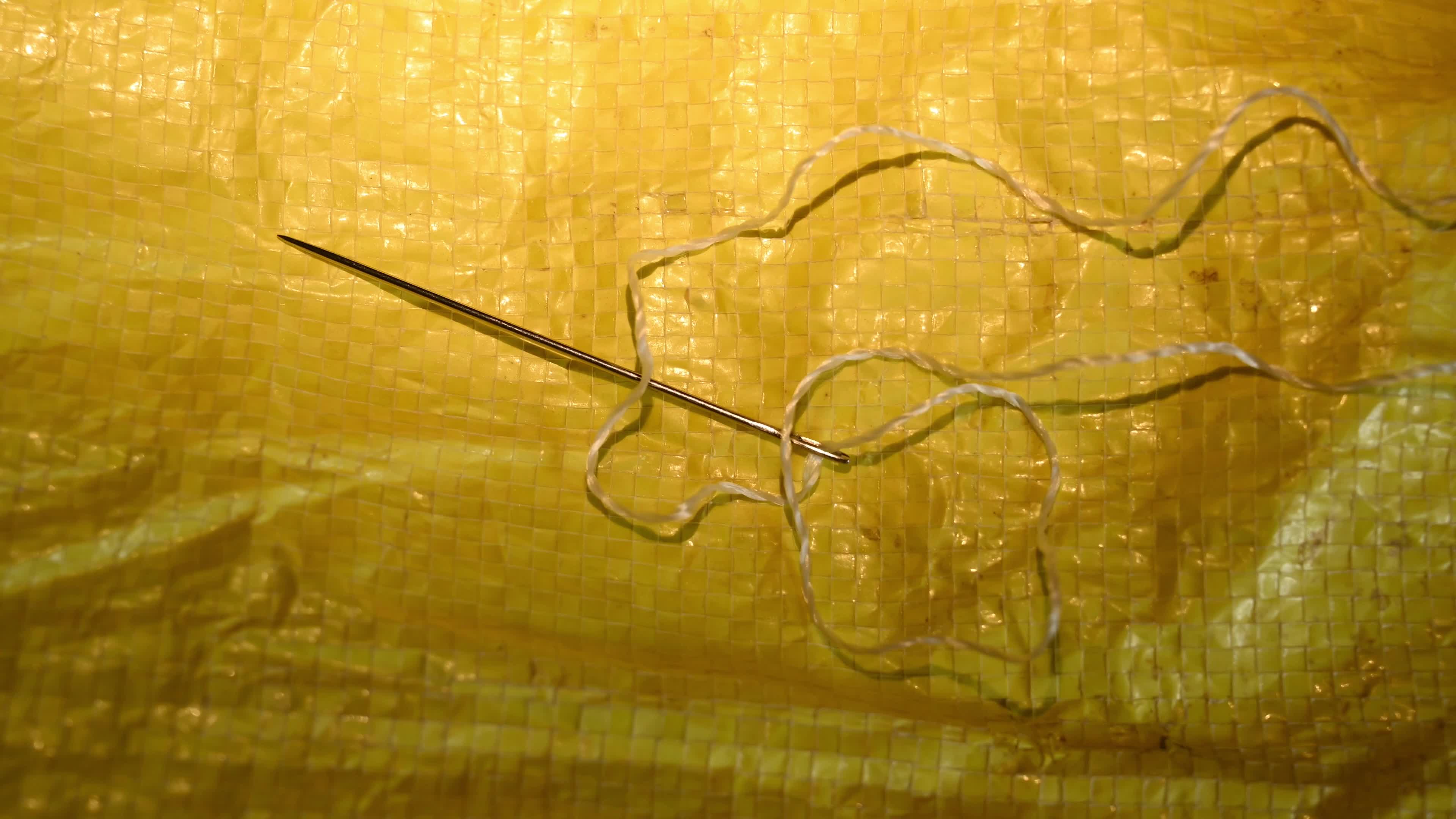 Manual sewing of a rice sack with thread - Sewing tool