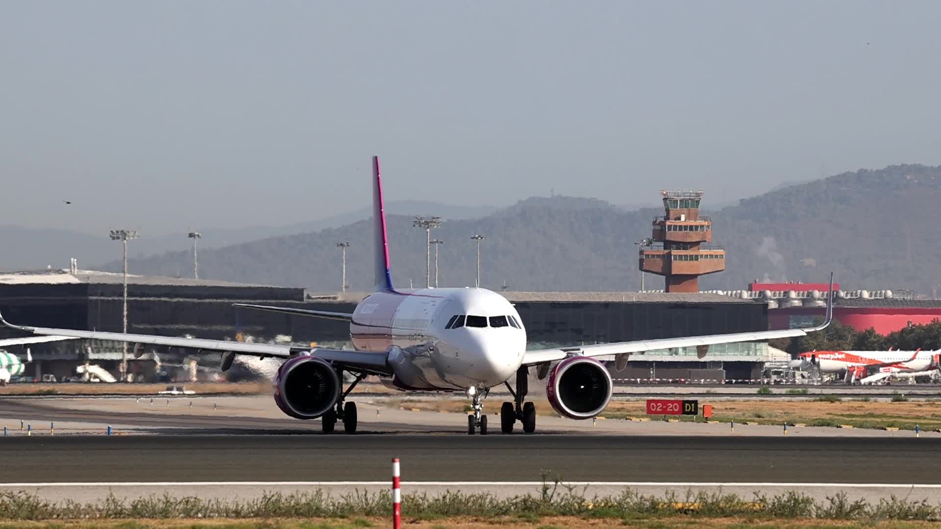 Wizz Air and Iberia aircraft prepare to take off from Barcelona Airport