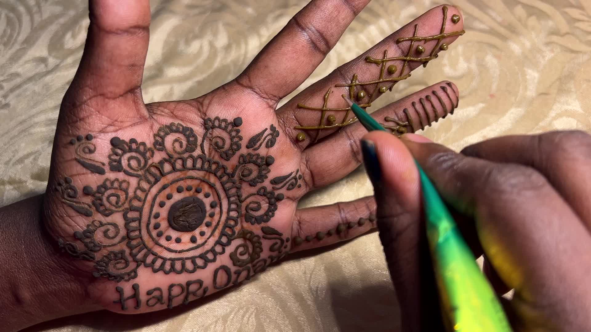 Mehndi is applied to the hands of a woman during the Onam festival