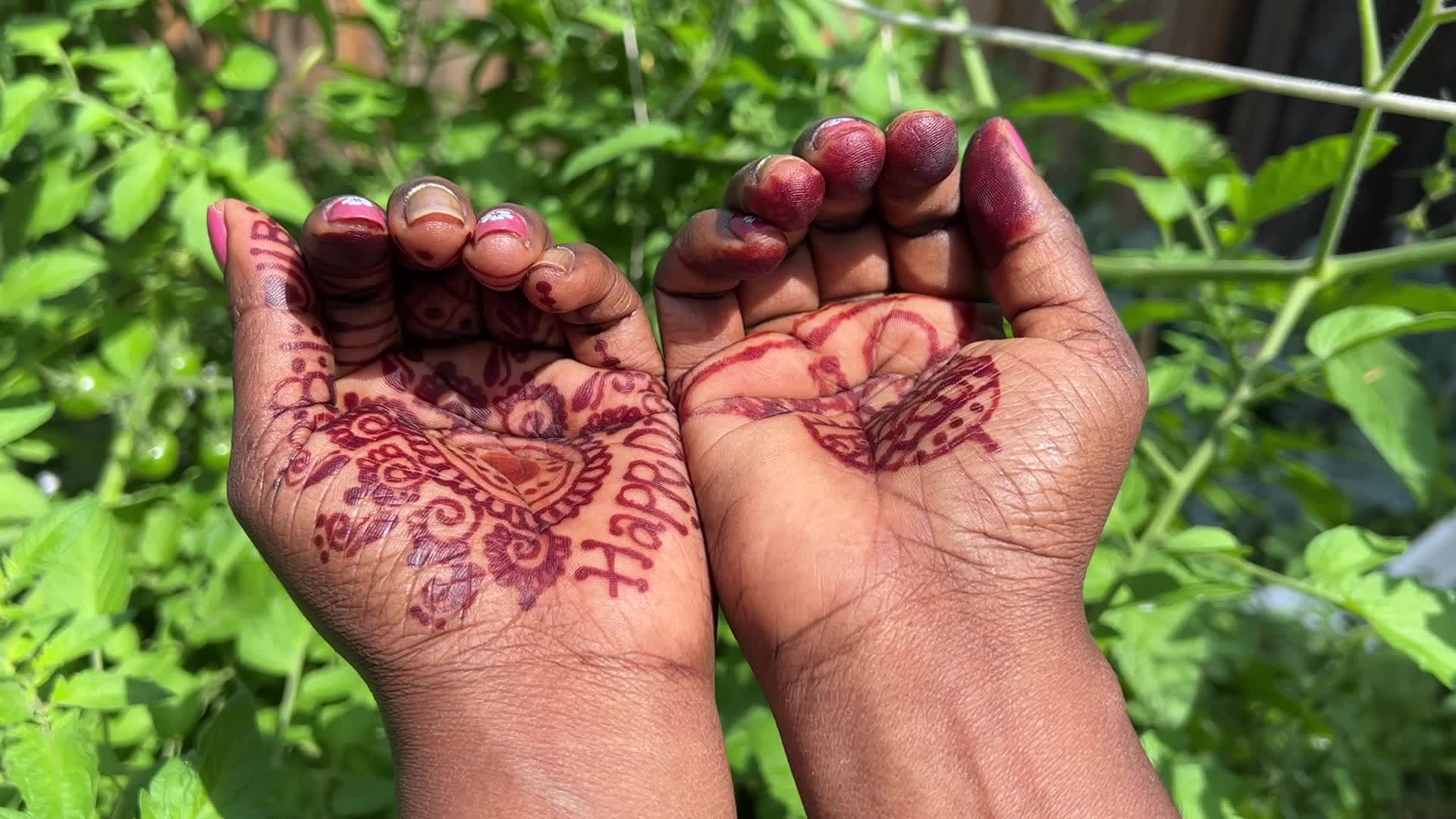Mehndi is applied to the hands of a woman during the Onam festival