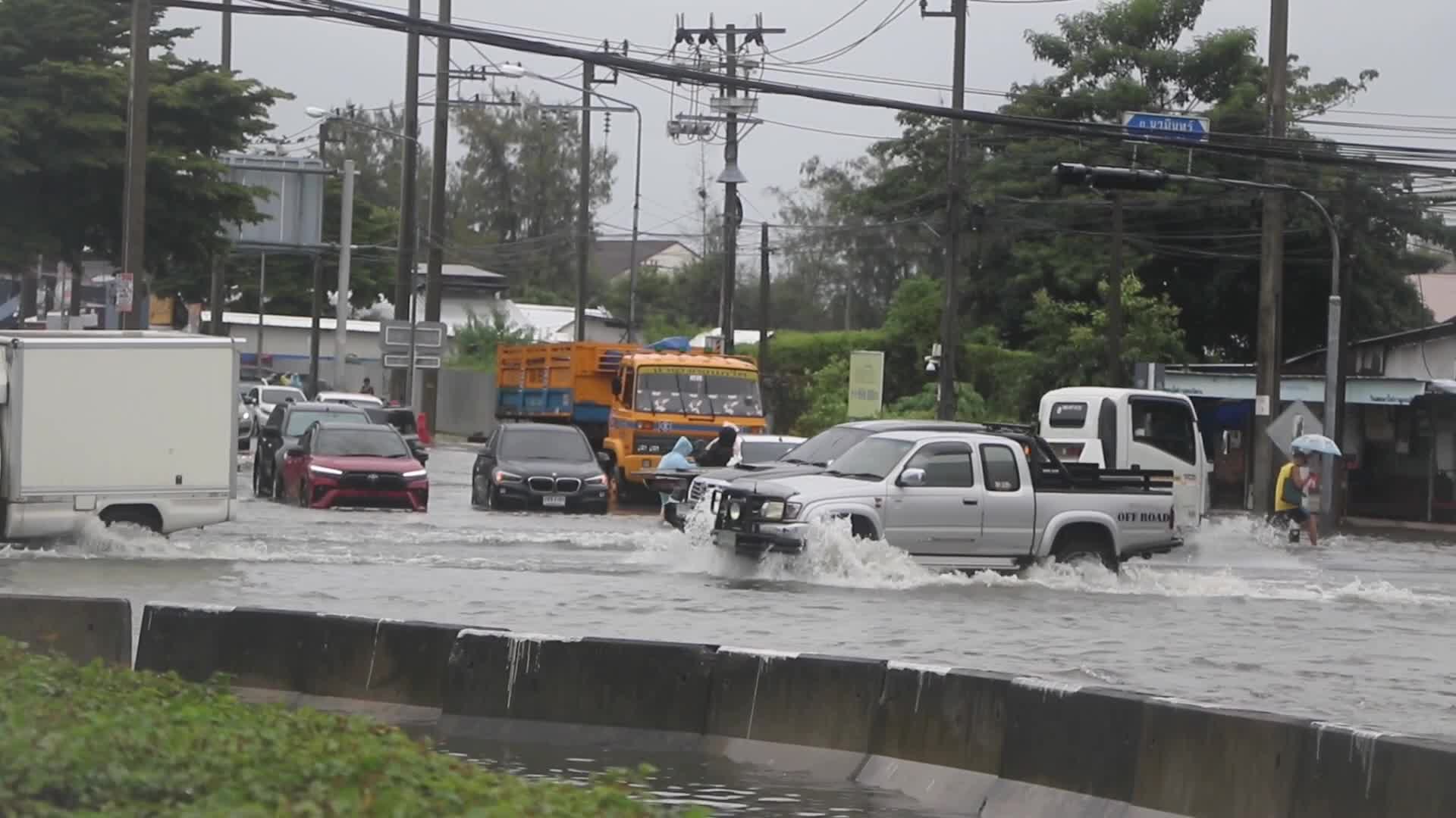 Residents  and motorists battle in floodwater.