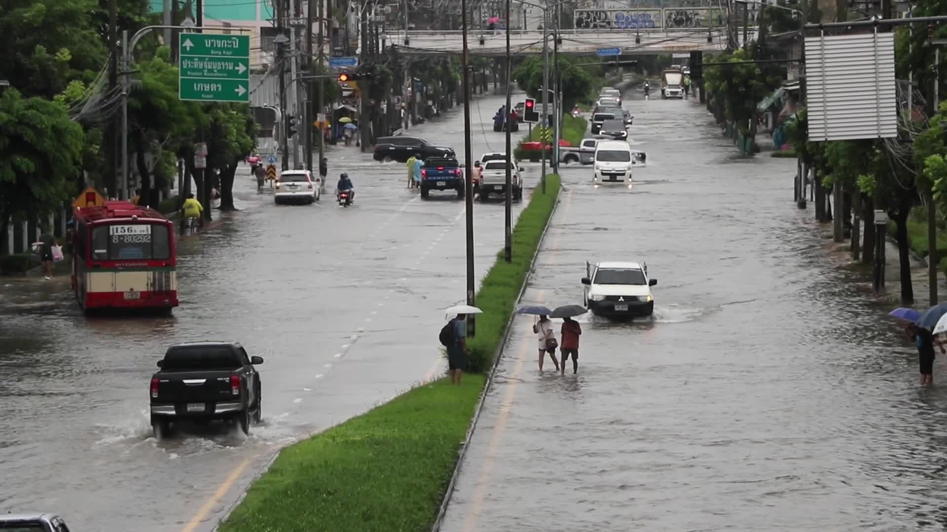 Residents  and motorists battle in floodwater.