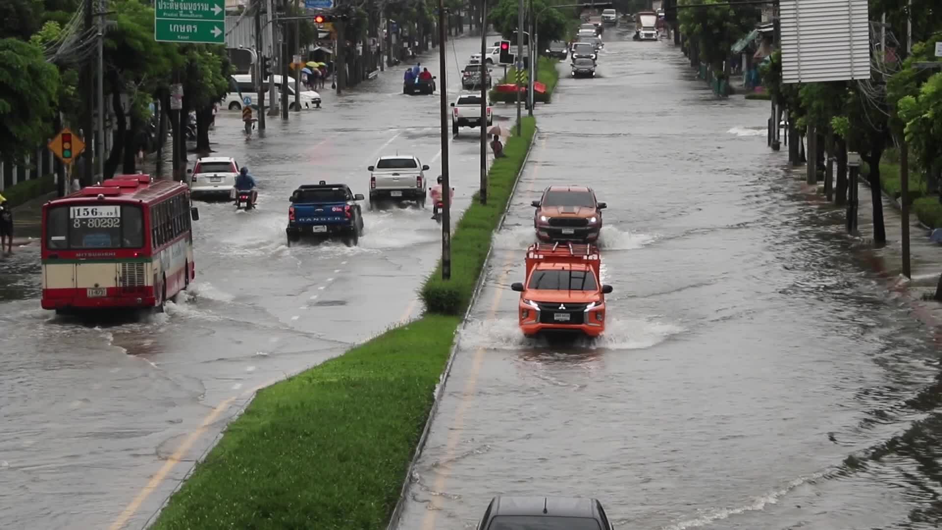 Residents  and motorists battle in floodwater.